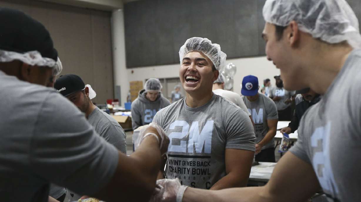 Vivint sales reps don hair nets, assemble more than a quarter million meals for orphans worldwide