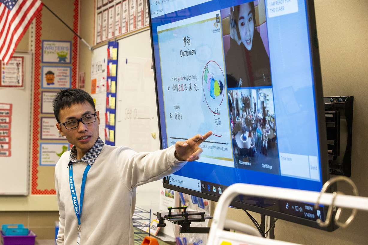 Intern Jiewen “Duke" Wu helps students at Fremont Elementary School in Sunset as online tutor Jenny teaches them Mandarin on Monday, Jan. 14, 2019. Once a week, students receive live online training from tutors from Qiao Qiao Chinese Education by Technology, which is based in Pleasanton, California. Many of the tutors are in China, although one of regulars is in Poland. (Photo: Scott G Winterton, KSL)
