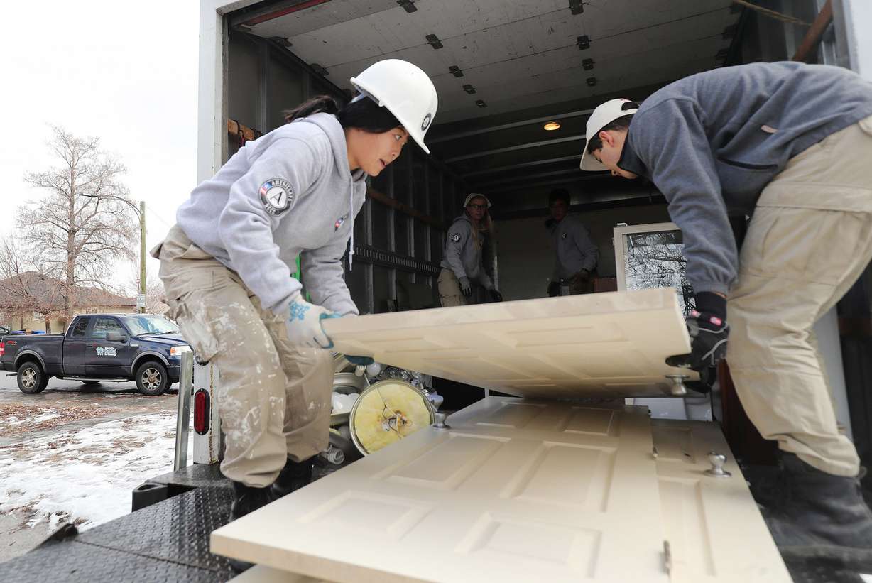 AmeriCorps volunteers Judy Park and Uri Sarig load doors from a Midvale home owned by the Utah Department of Transportation on Wednesday, Jan. 16, 2019. (Photo: Jeffrey D. Allred, KSL)