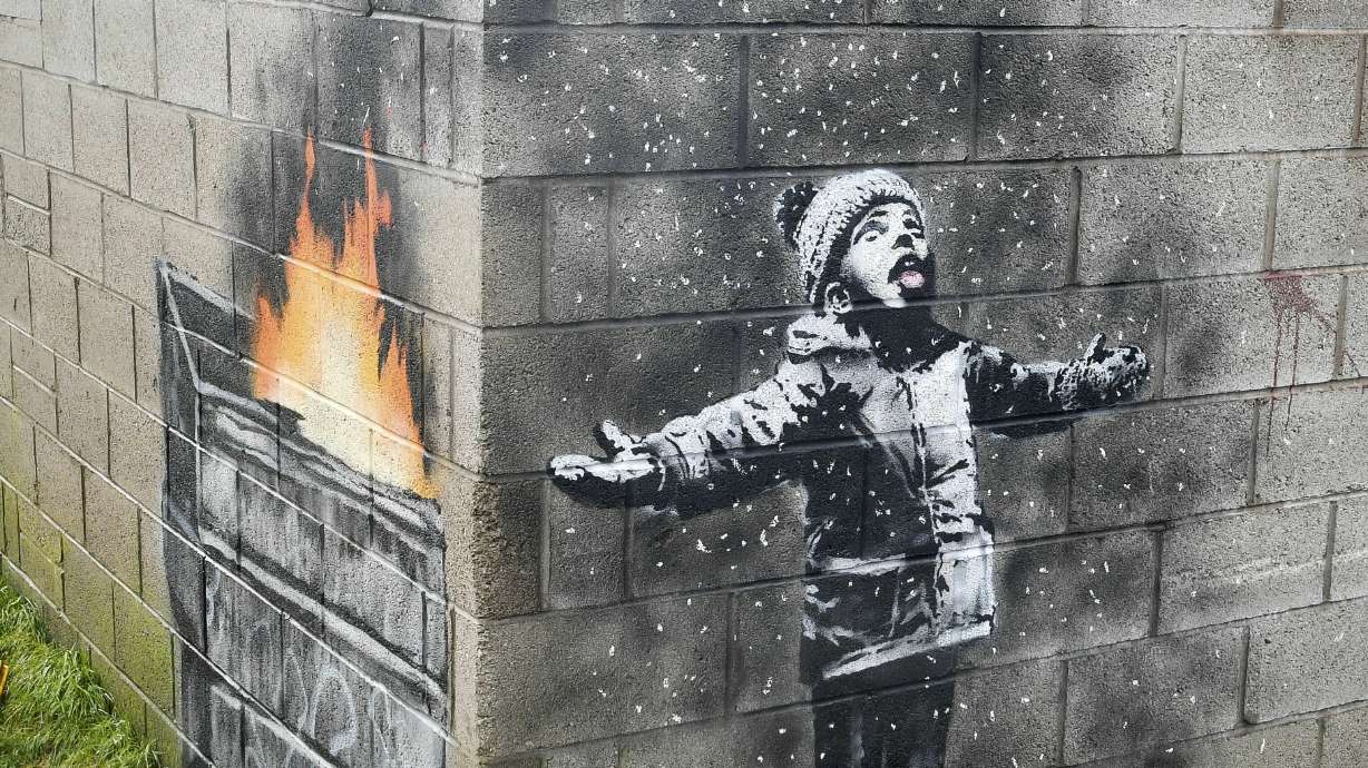 Banksy mural on garage in Wales sold but will stay in place