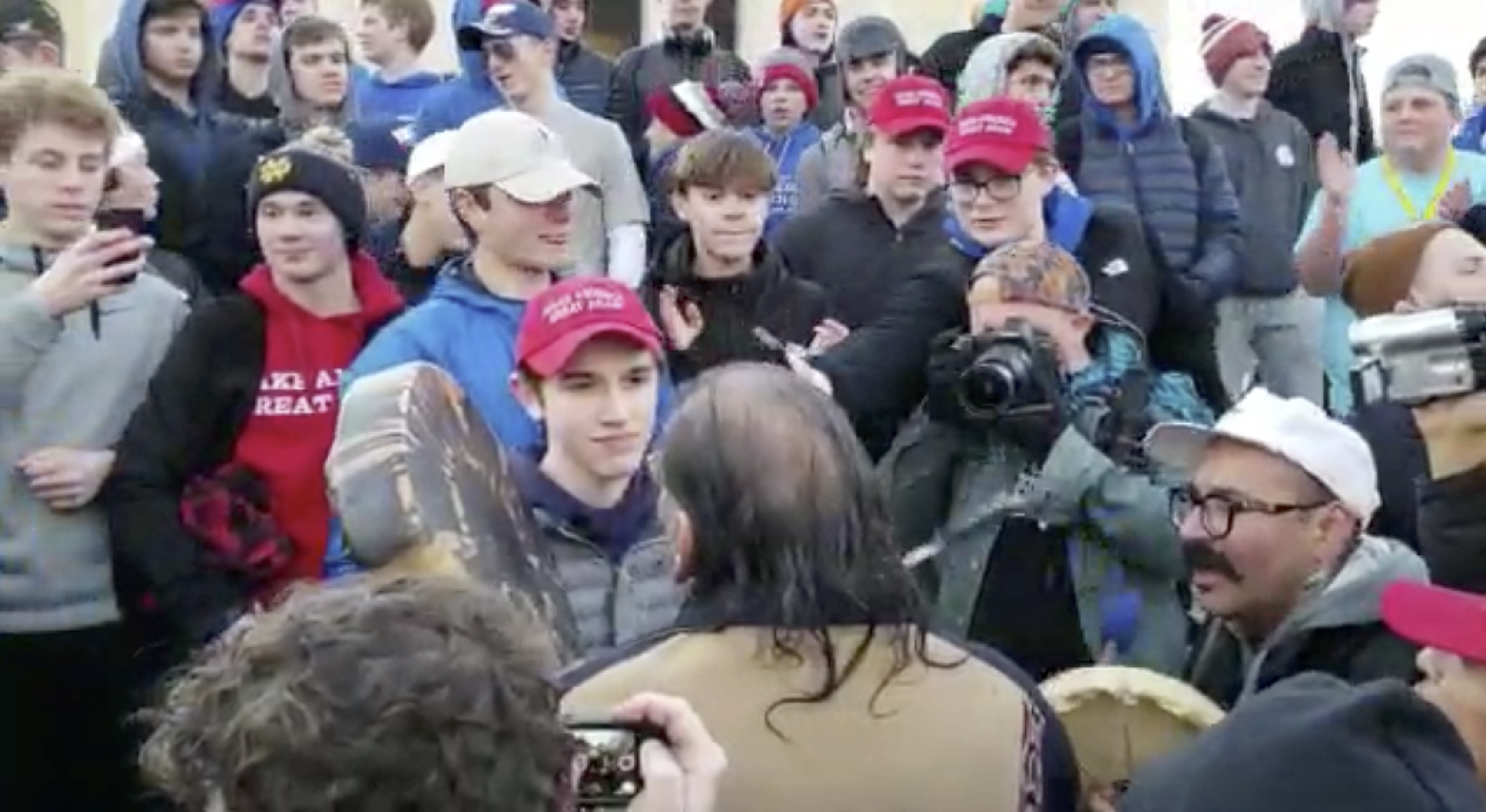 Students in 'MAGA' hats mock Native American after rally