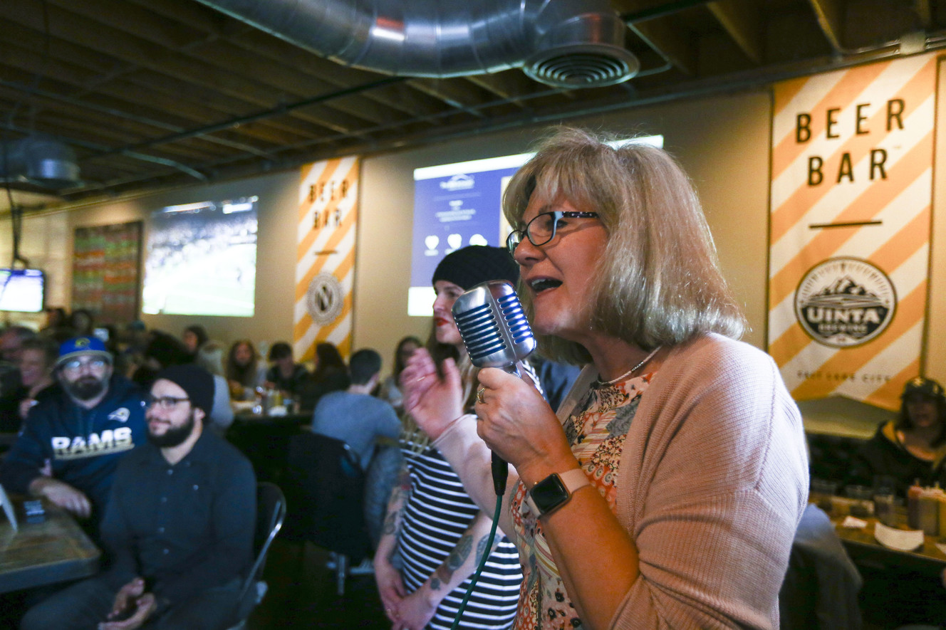 Kim Correa, executive director at the Inn Between, makes announcements during a fundraiser organized by YIMBY Group members to raise money for the facility, which provides hospice care for people experiencing homelessness, at the Beer Bar in Salt Lake City on Sunday, Jan. 20, 2019. (Photo: Silas Walker, KSL)