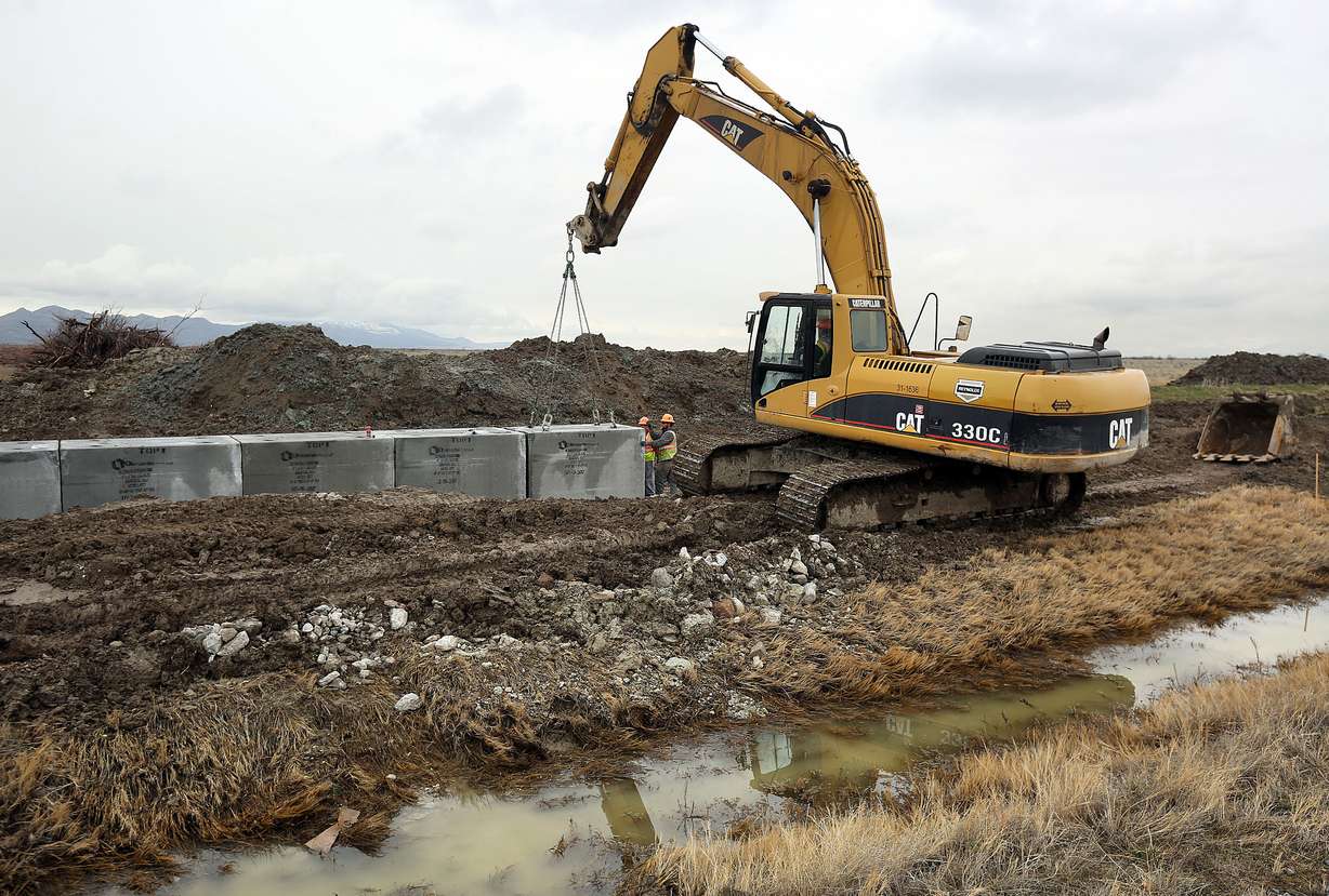 Workers install a concrete culvert to go under a temporary haul road for construction of the new prison in Salt Lake City on Wednesday, Feb. 22, 2017. (Photo: Kristin Murphy, KSL, File)