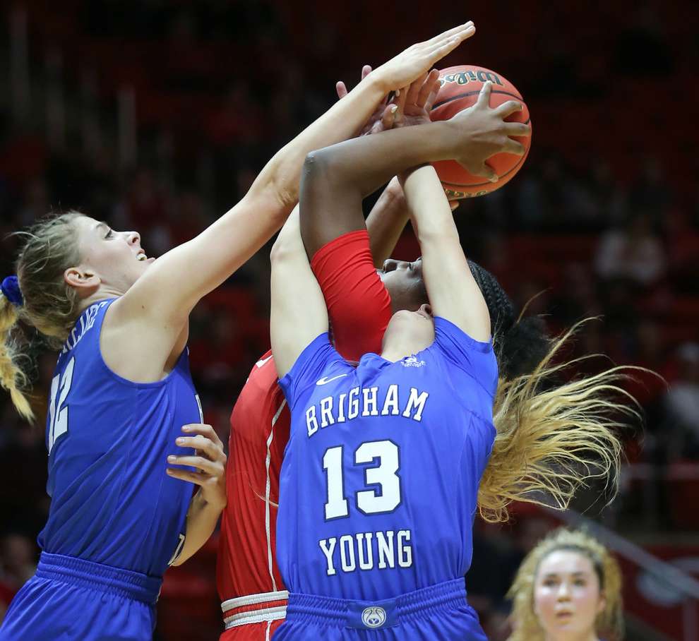 BYU guard Caitlyn Alldredge and BYU guard Paisley Johnson (13) battle Utah forward Dre'Una Edwards (44) for the ball as Utah and BYU women play at the Huntsman Center at the University of Utah in Salt Lake City on Saturday, Dec. 8, 2018. Utah won 78-67. (Photo: Scott G Winterton, Deseret News)