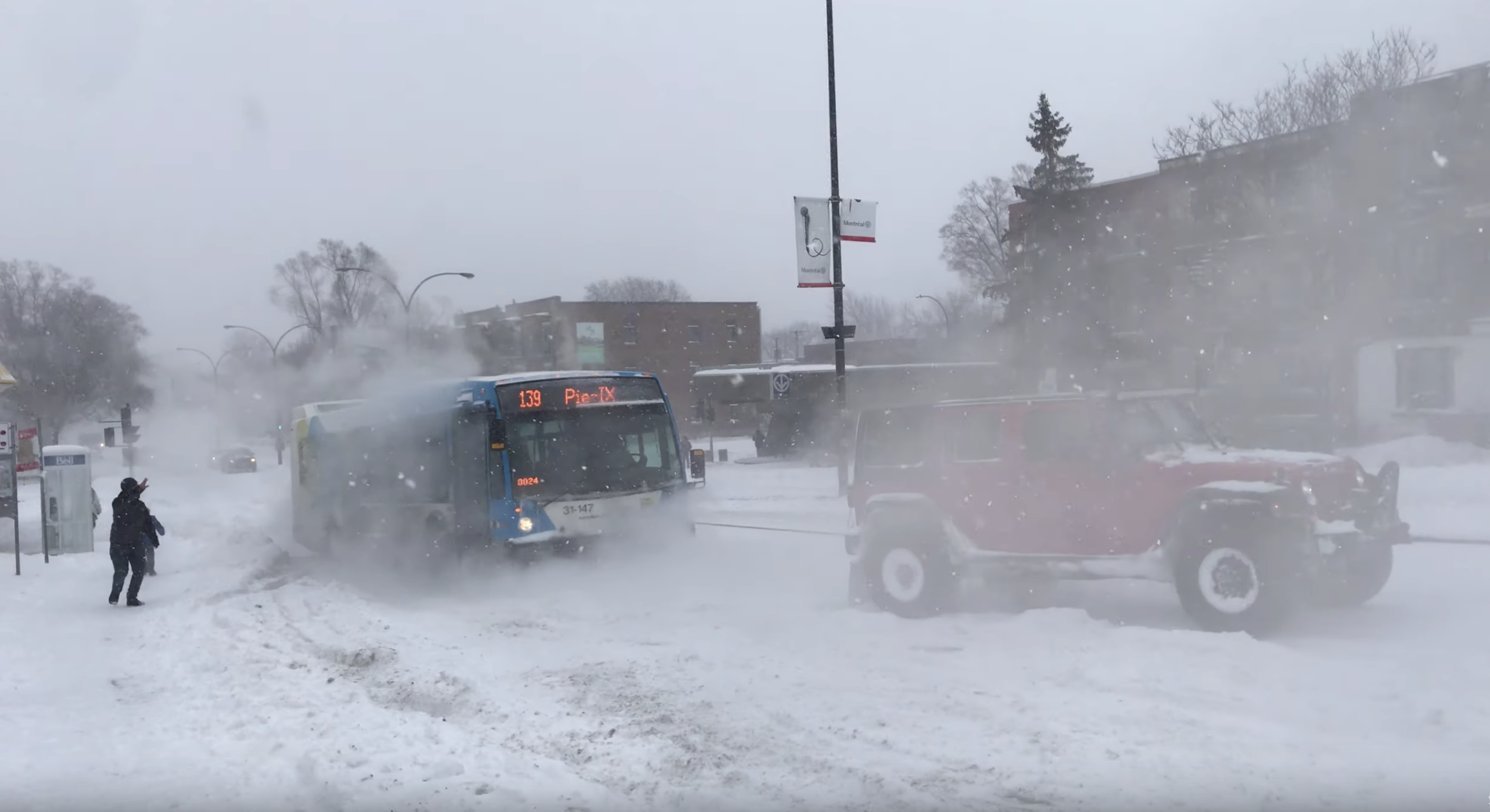 Have You Seen This? 3 vehicles pull bus full of passengers up snowy hill