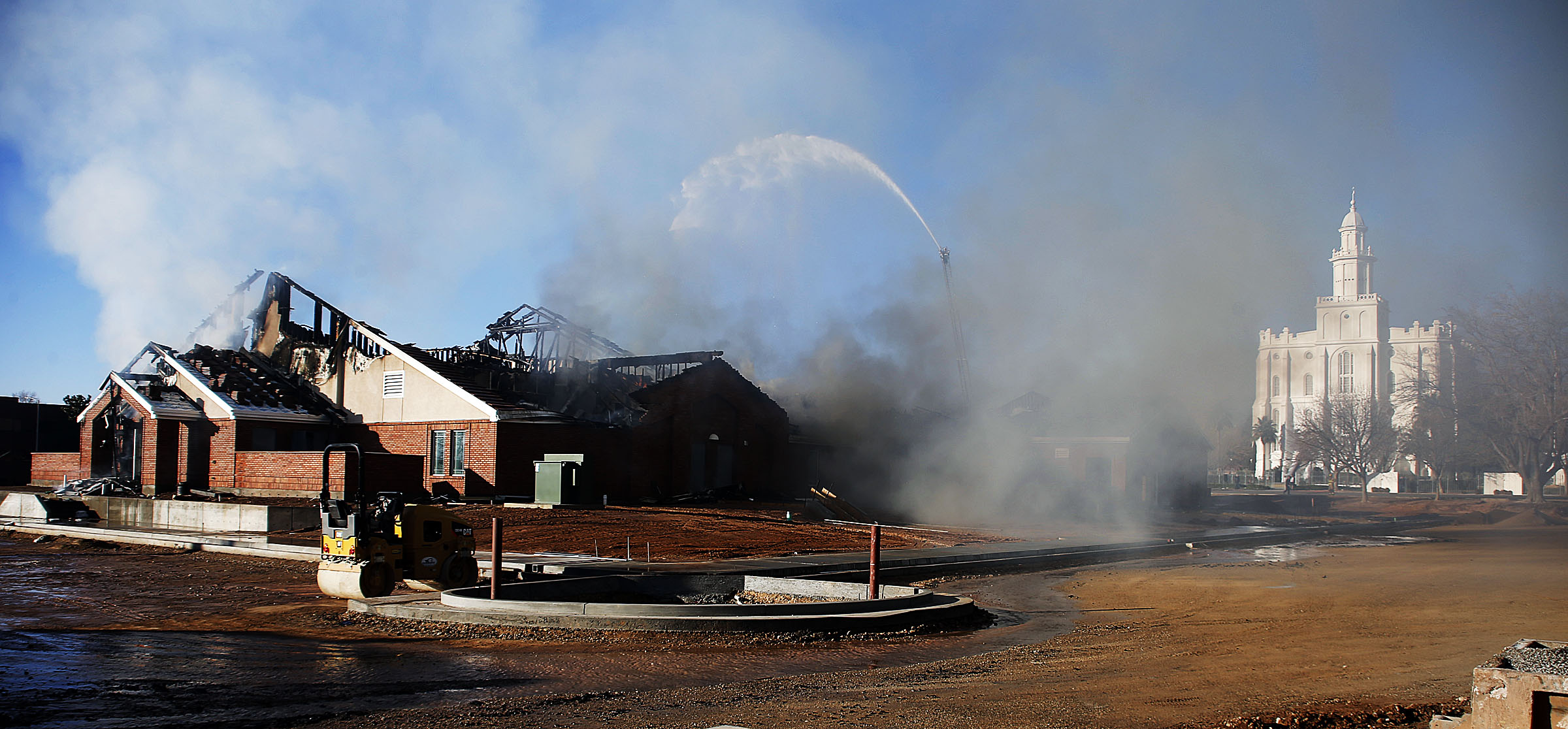 Firefighters work at the scene of a fire at the St. George East Stake Center of the Church of Jesus Christ of Latter-day Saints on Saturday, Jan. 26, 2019. At right is the St. George Temple. (Photo: Ravell Call, KSL)