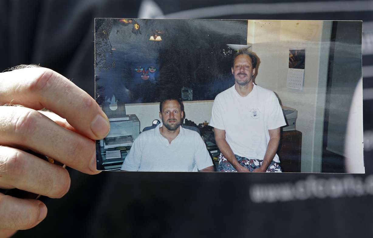 FILE - In this Oct. 2, 2017 file photo, Eric Paddock holds a photo of himself, at left, and his brother, Stephen Paddock, at right, outside his home in Orlando, Fla. Photo: AP Photo