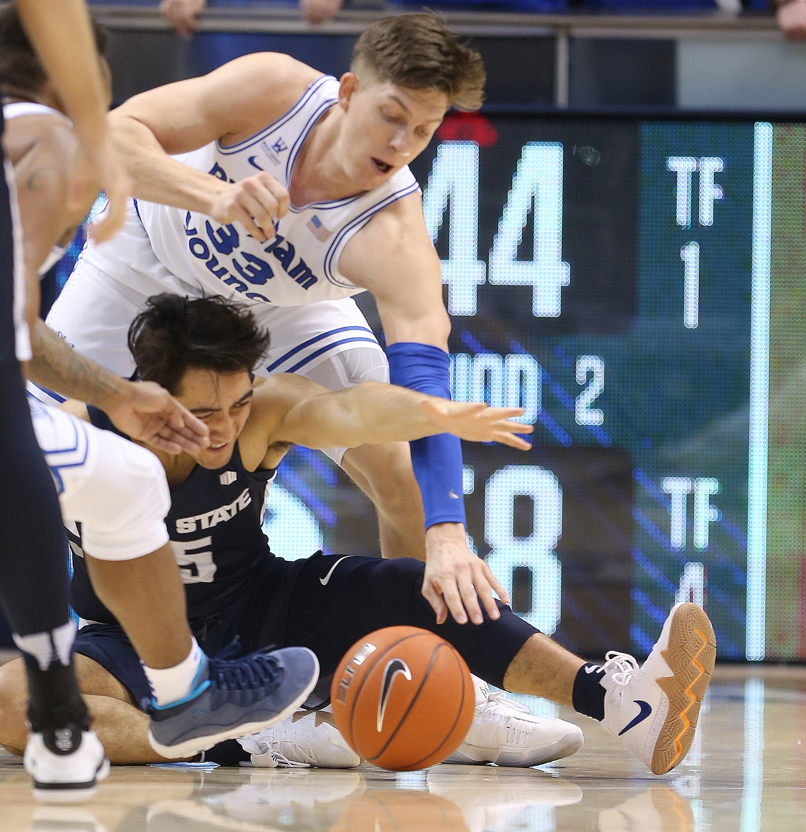 Utah State Aggies guard Abel Porter (15) and Brigham Young Cougars forward Dalton Nixon (33) fight for the ball in Provo on Wednesday, Dec. 5, 2018. BYU won 95-80. (Photo: Jeffrey D. Allred, KSL)