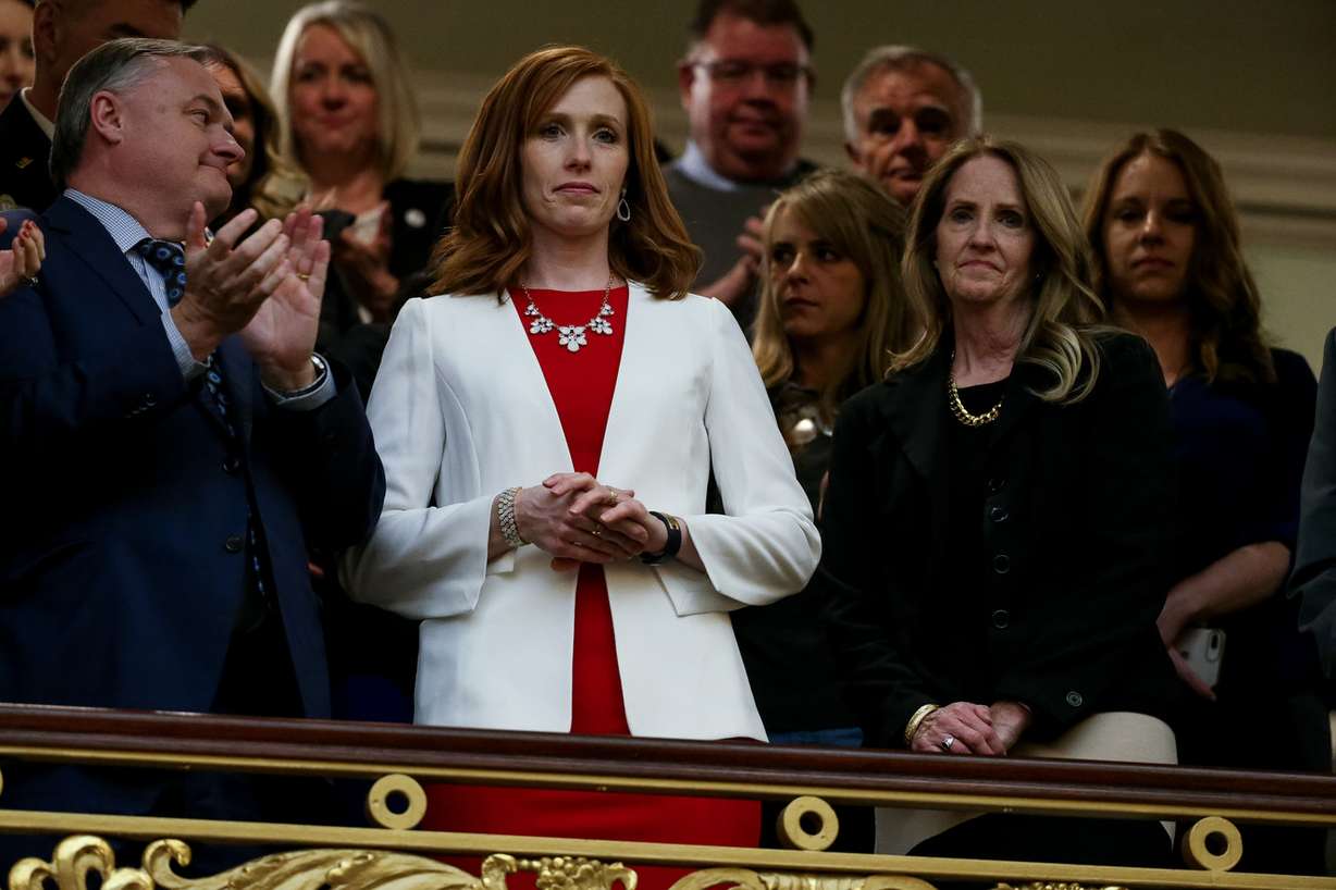 Jennie Taylor, wife of slain Utah National Guard Maj. Brent Taylor, center, and Tammy Taylor, Maj. Taylor's mother, stand as the House chamber audience rises to honor the families of Utahns killed in the line of duty in the last year during Gov. Gary Herbert's State of the State address at the Capitol in Salt Lake City on Wednesday, Jan. 30, 2019. (Photo: Spenser Heaps, KSL)