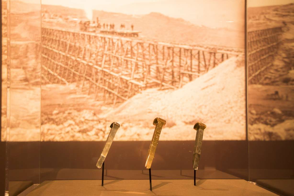The golden spike, center, flanked by the Arizona and Nevada spikes put on display at the Utah Museum of Fine Arts during a tour on Thursday, Jan. 31, 2019. It's the first time all three spikes, which were presented at the merging of the rails, have been in Utah since 1869. The location of a fourth spike presented that day is unknown. (Photo: Carter Williams, KSL.com)
