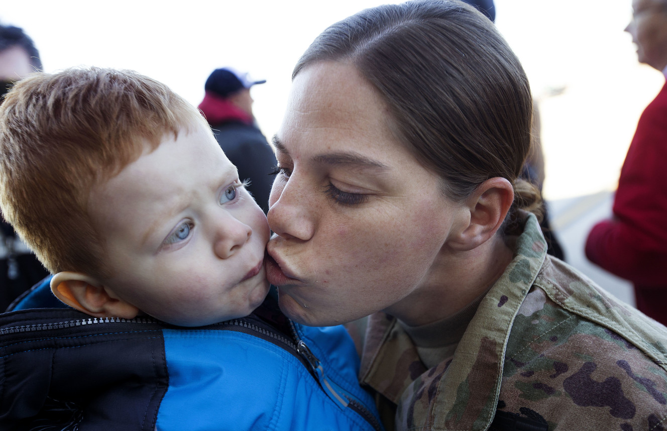 Kolton Labrum, 22 months, gets a kiss from his mother, Utah Army National Guard Sgt. Jullienne Labrum at the Utah Air National Guard’s Roland R. Wright Air Base in Salt Lake City on Thursday, Jan. 31, 2019, after the 65th Field Artillery Brigade returned from a more than 10-month deployment in the Middle East. (Photo: Laura Seitz, KSL)