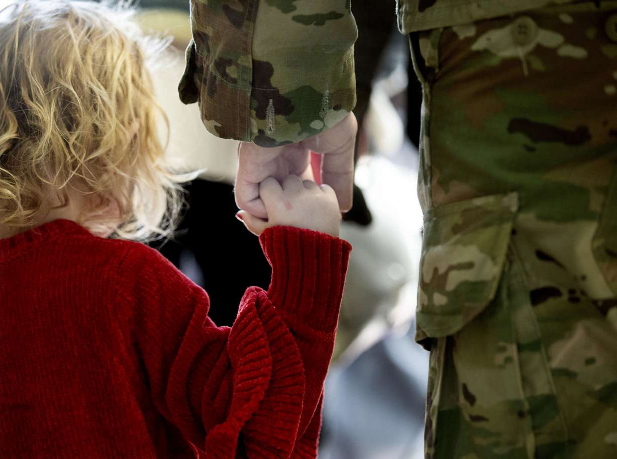 Blakeli Jackson and her father, Utah Army National Guard Spc. Zachary Jackson hold hands at the Utah Air National Guard’s Roland R. Wright Air Base in Salt Lake City on Thursday, Jan. 31, 2019, after the 65th Field Artillery Brigade returned from a more than 10-month deployment in the Middle East. (Photo: Laura Seitz, KSL)