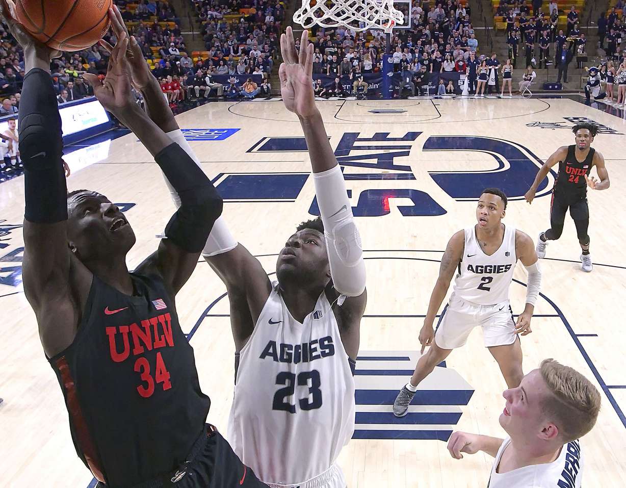 UNLV forward Cheikh Mbacke Diong (34) has his shot blocked by Utah State center Neemias Queta (23) during an NCAA college basketball game Saturday, Feb. 2, 2019, in Logan, Utah. (Eli Lucero/The Herald Journal via AP)