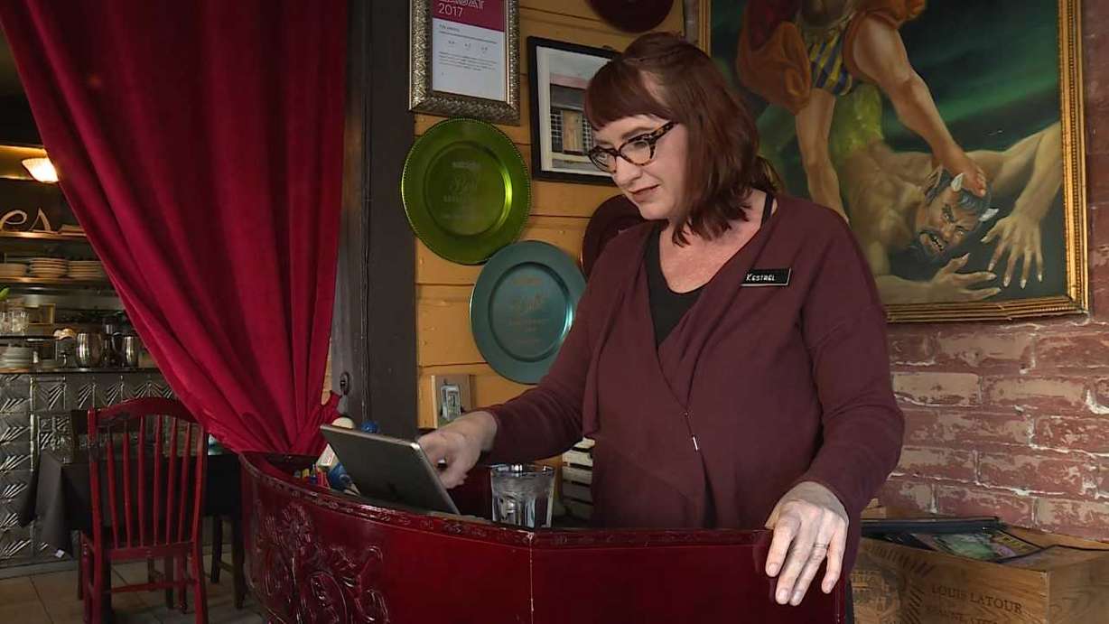 Kestrel Liedtke, owner of the Tin Angel Cafe, operates the sales register. (Photo: KSL TV)