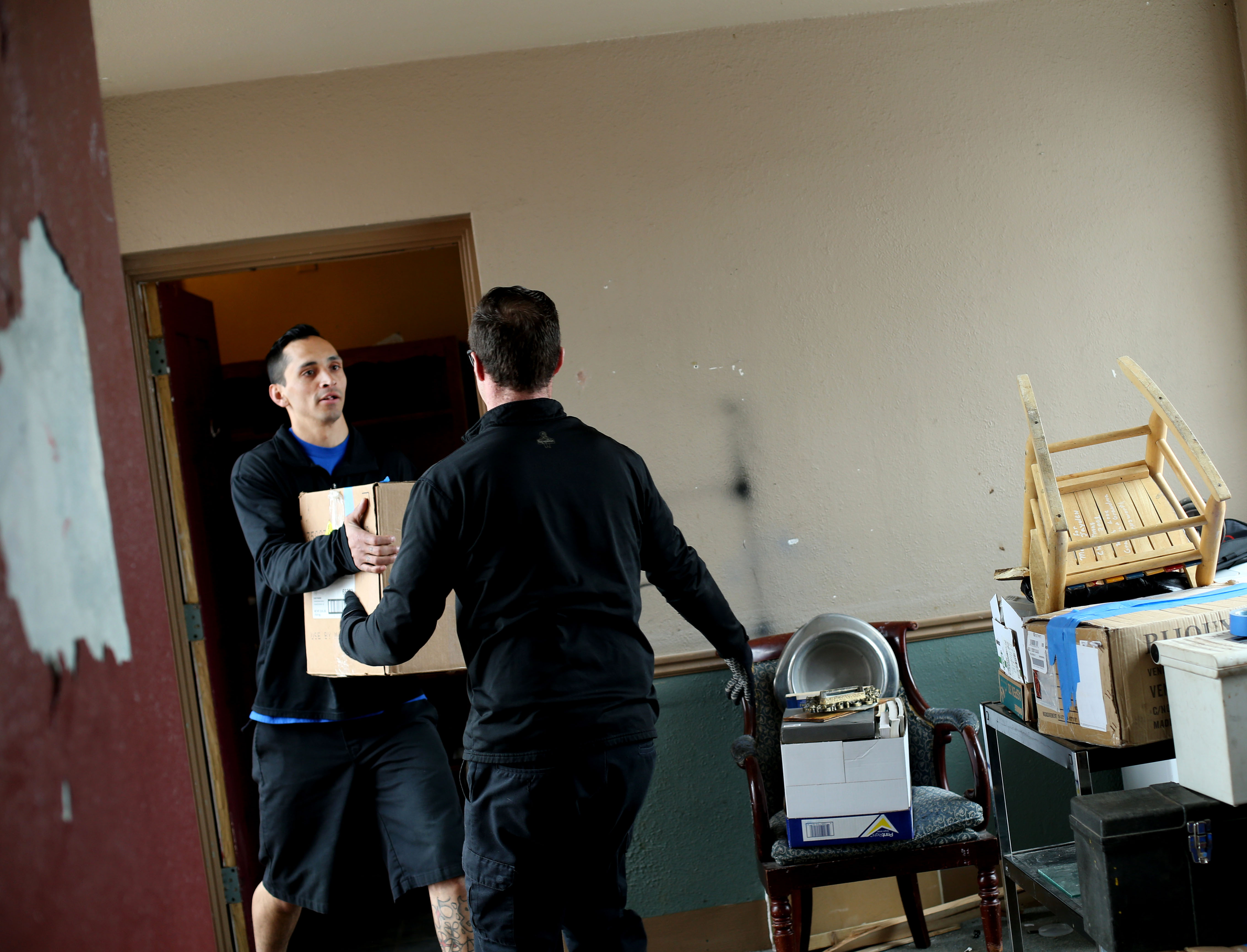 Austin Nicholas and Shylo Martinez, with the Other Side Academy, move a tenant's belongings out of the Georgia Apartments in Salt Lake City on Thursday, Feb. 14, 2019. (Photo: Laura Seitz, KSL)