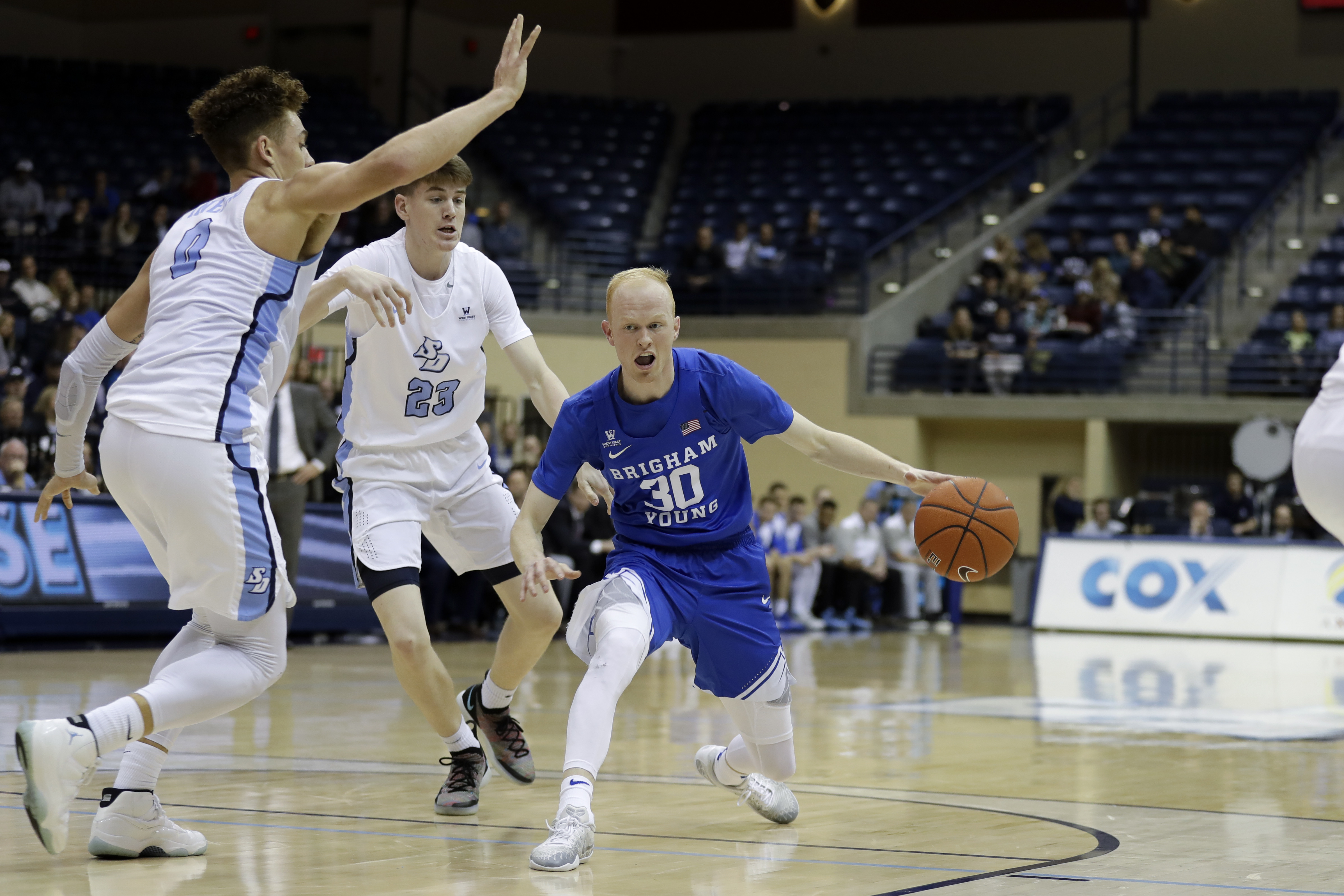 Brigham Young guard TJ Haws, right, drives to the basket as San Diego forward Isaiah Pineiro, left, and guard Finn Sullivan, center, defend during the first half of an NCAA college basketball game, Thursday, Feb. 14, 2019, in San Diego. (Photo: Gregory Bull, AP)