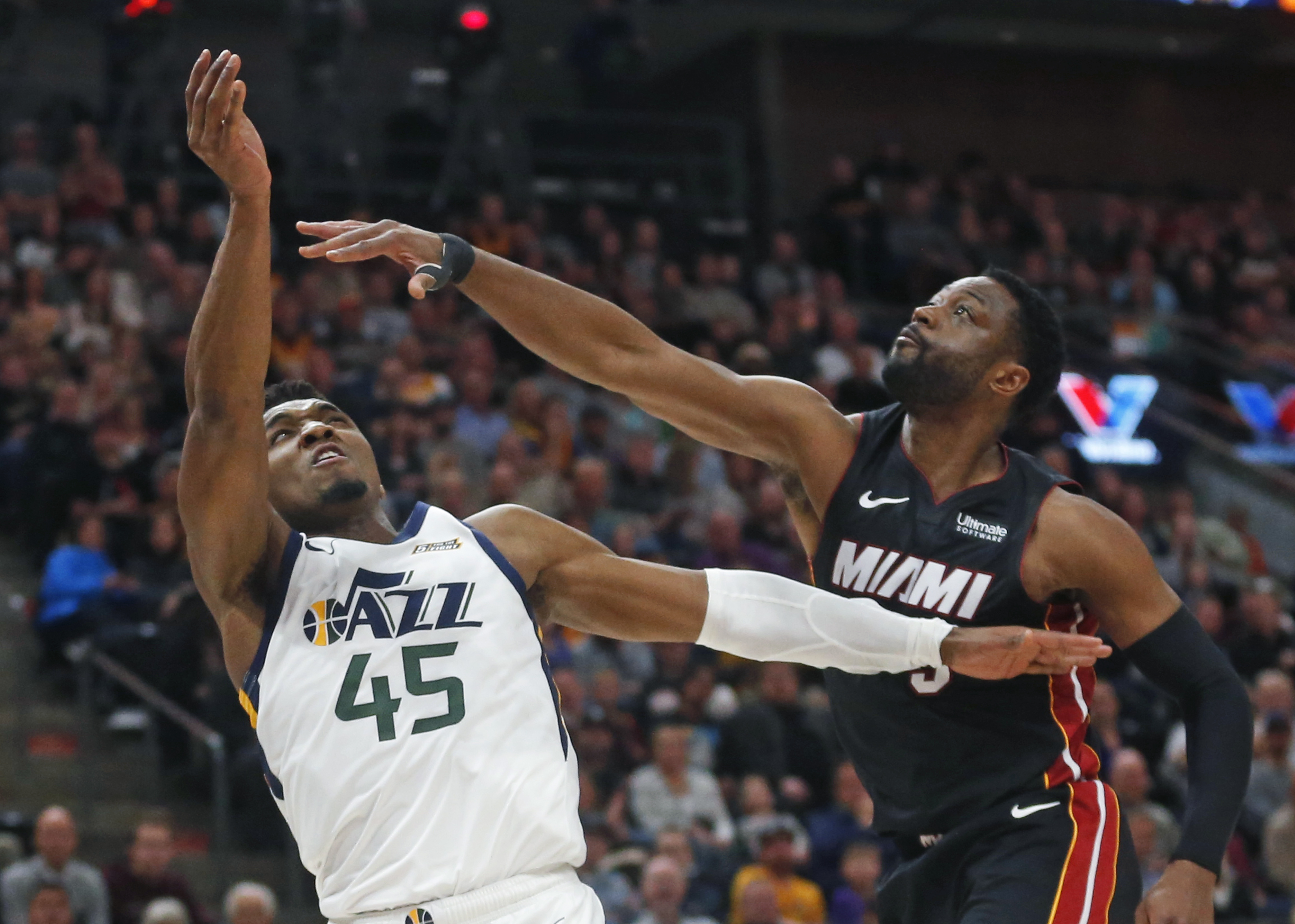 Miami Heat guard Dwyane Wade (3) defends against Utah Jazz guard Donovan Mitchell (45) in the second half during an NBA basketball game Wednesday Dec. 12, 2018, in Salt Lake City. (AP Photo/Rick Bowmer)