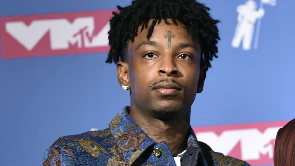 The Latest: 21 Savage surrenders on outstanding warrant