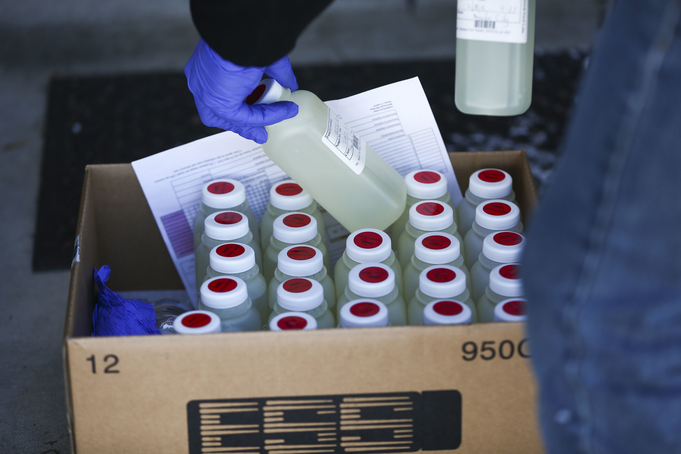 Ron Lund and Ray Herrera take water samples to be analyzed from homes in the affected area in Sandy on Monday, Feb. 18, 2019. (Photo: Silas Walker, KSL)