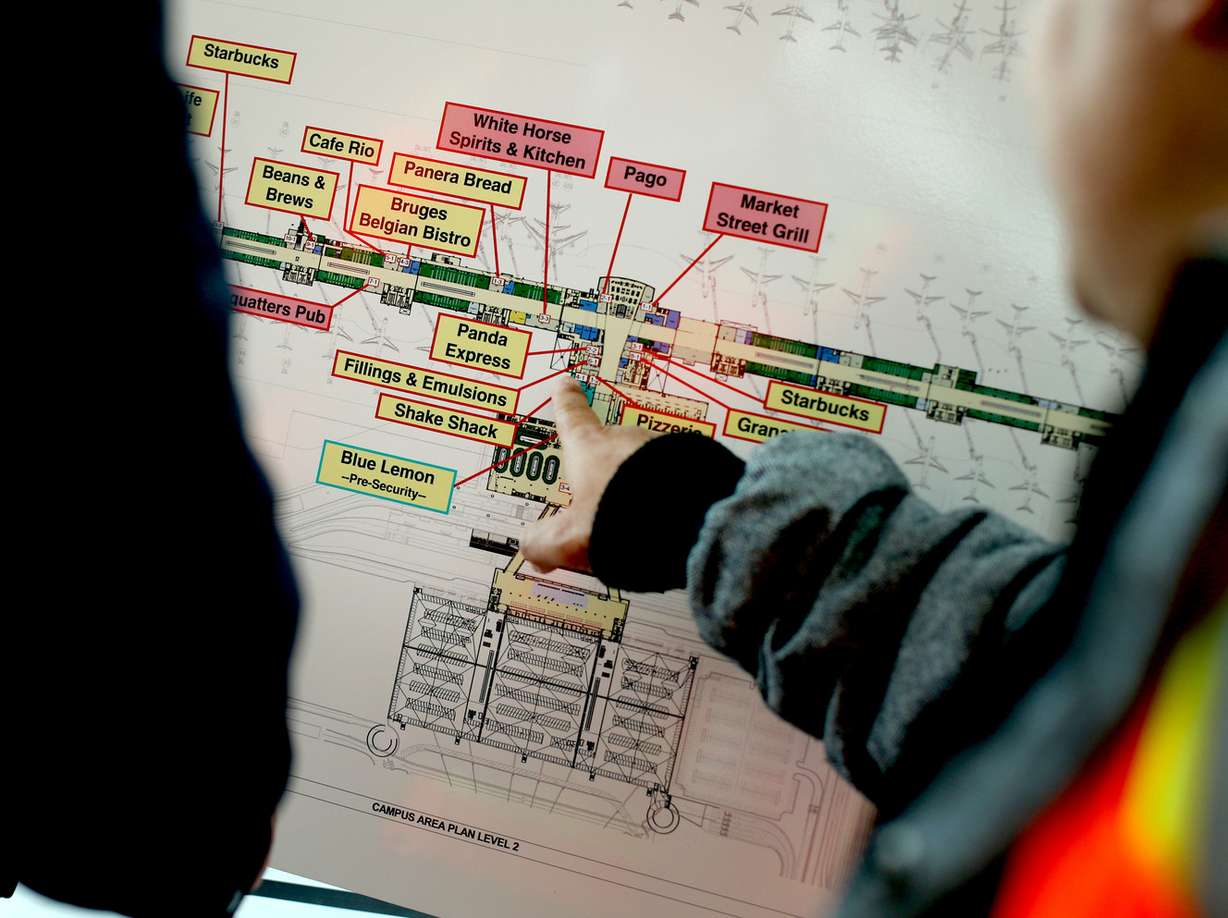 Guests look at the list of food and beverage vendors that have been selected for a plaza in one of the concourses being built at the Salt Lake City International Airport on Wednesday, Feb. 20, 2019. (Photo: Laura Seitz, KSL)