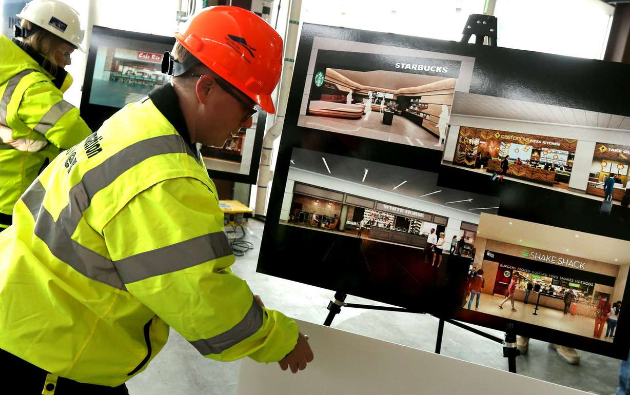 Public relations coordinator Elenor Gomberg unveils photographs of the food and beverage component for the first phase of the $3.6 billion remodel of the Salt Lake City International Airport on Wednesday, Feb. 20, 2019. (Photo: Laura Seitz, KSL)