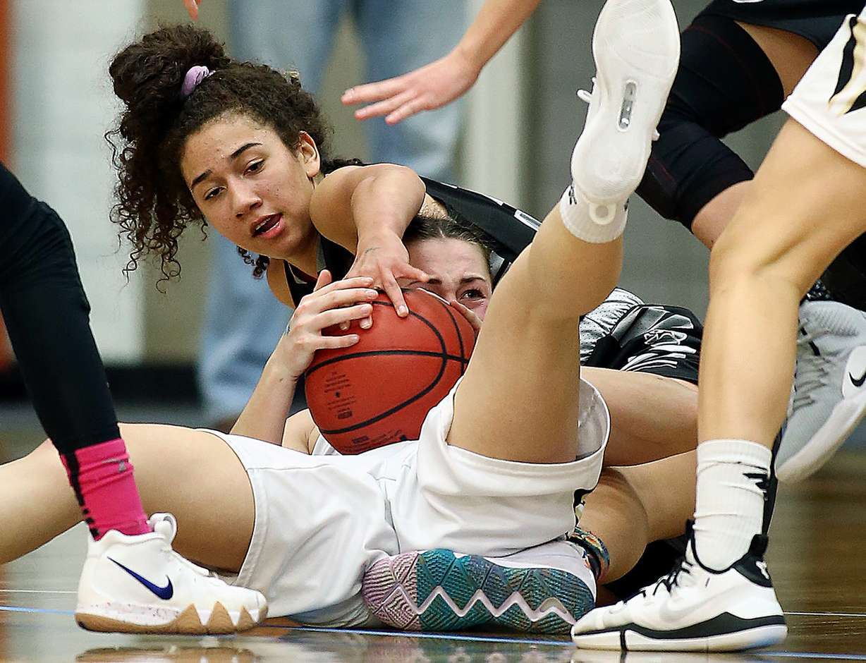 Riverton's Avalon Miller wrestles with Lone Peak's Makale Easton for the ball as they compete in 6A quarterfinal basketball action at Salt Lake Community College in Taylorsville on Wednesday, Feb. 20, 2019. Lone Peak won 65-40. (Photo: Scott G Winterton, Deseret News)