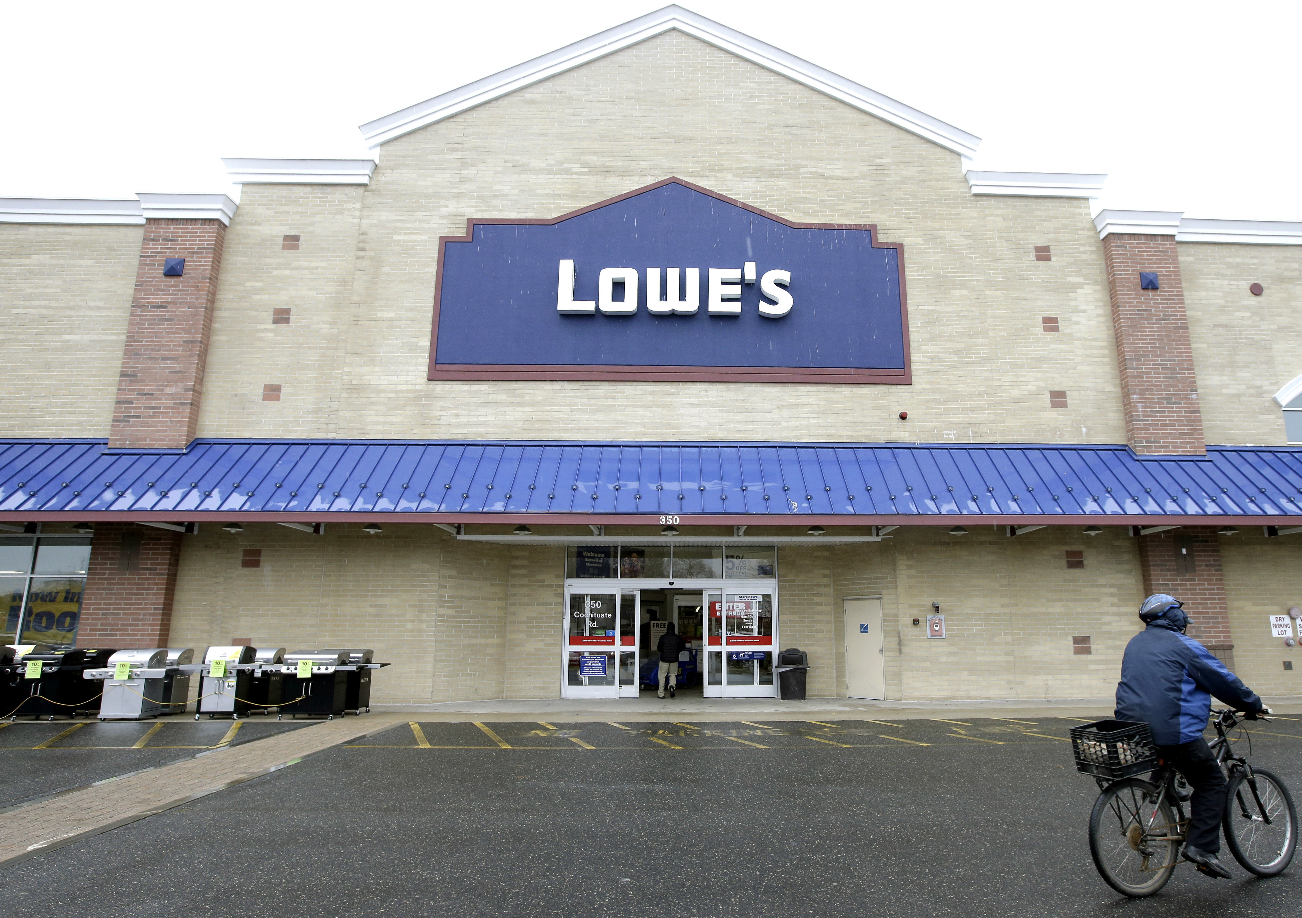 Lowe's swings to 4Q loss on charges, anemic housing market