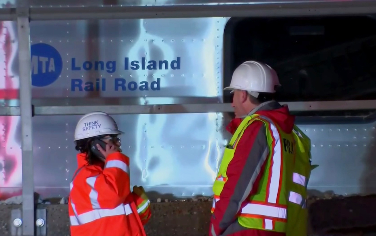 The Latest: Witness says car in train crash was fleeing