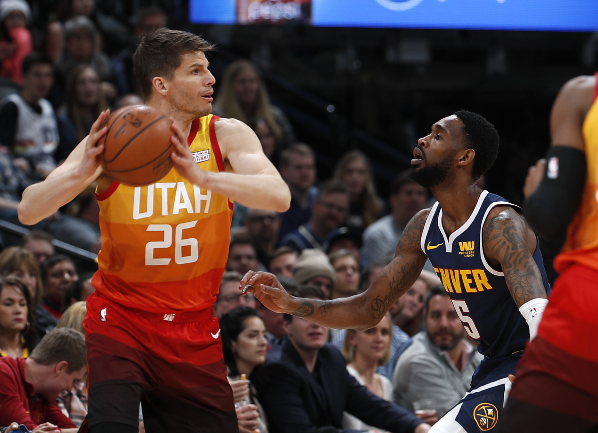 Utah Jazz guard Kyle Korver, left, looks to pass the ball as Denver Nuggets guard Will Barton defends during the first half of an NBA basketball game Thursday, Feb. 28, 2019, in Denver. (AP Photo/David Zalubowski)