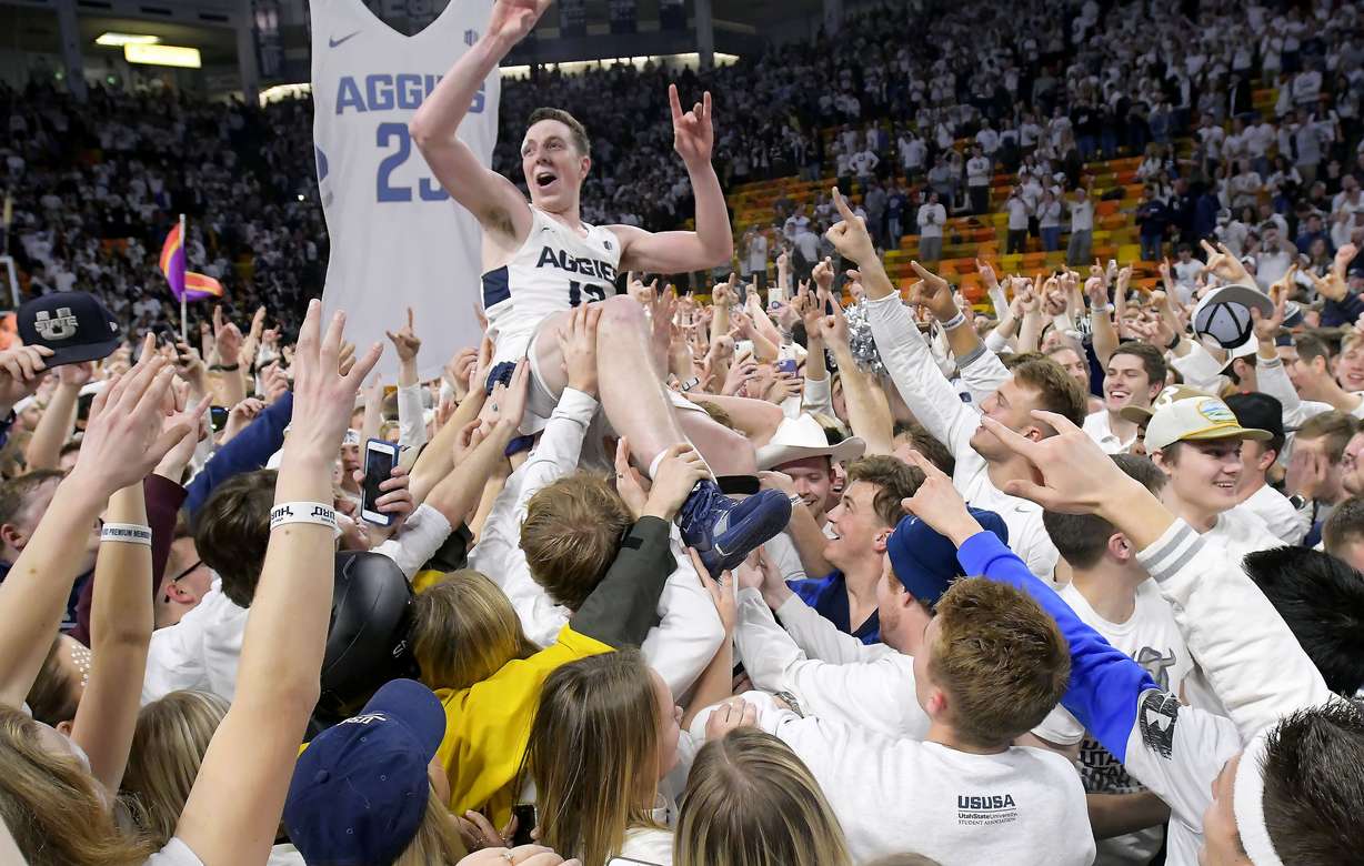 Fans celebrate with Utah State forward Justin Bean on the court after Utah State defeated Nevada 81-76 in an NCAA college basketball game Saturday, March 2, 2019, in Logan, Utah. (Photo: Eli Lucero, The Herald Journal via AP)