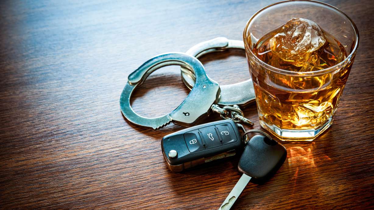 Whiskey with car keys and handcuffs. Concept for drinking and driving. Law