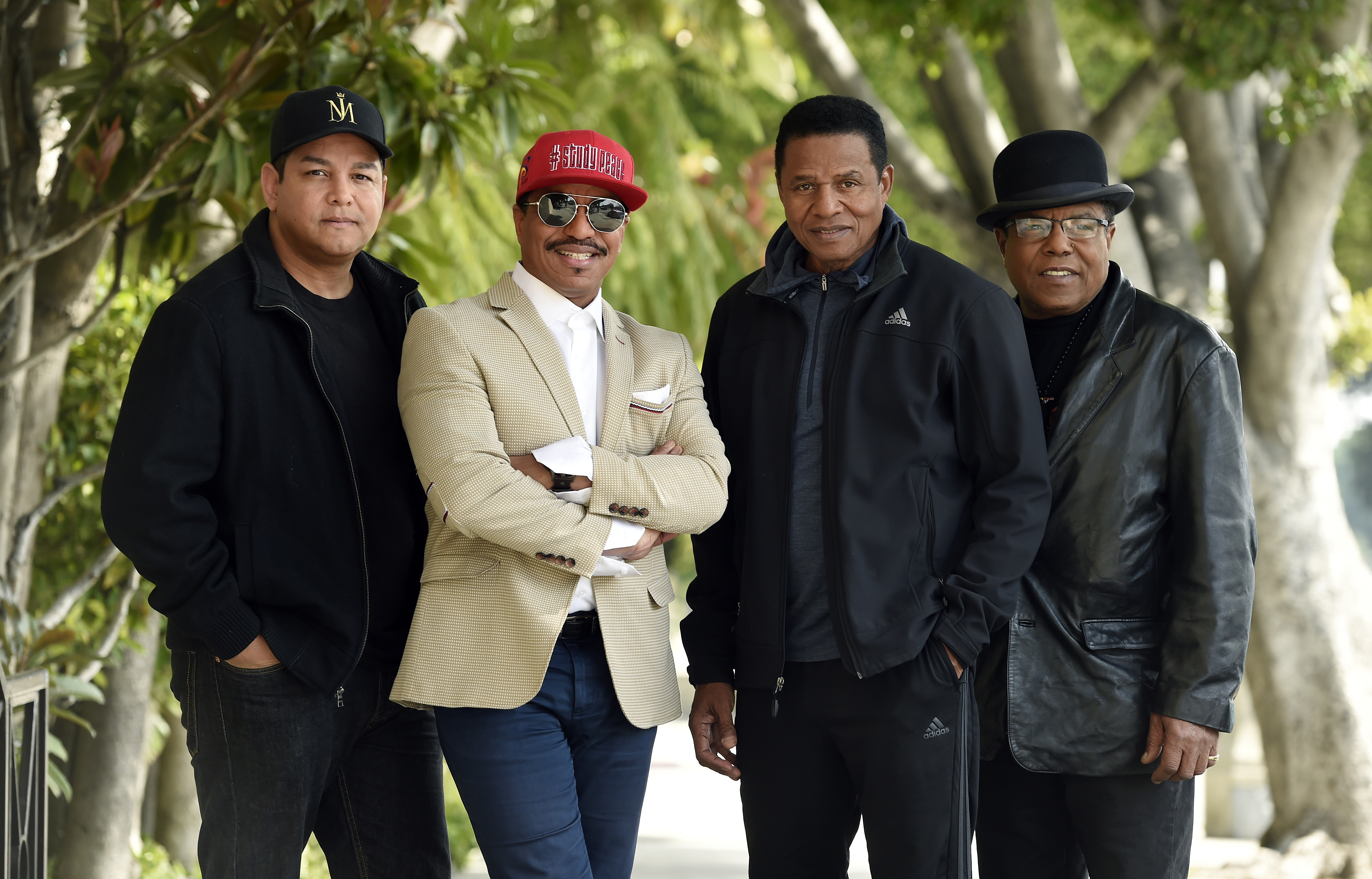 In this Tuesday, Feb. 26, 2019, file photo, Marlon Jackson, second from left, Jackie Jackson, second from right, and Tito Jackson, far right, brothers of the late singer Michael Jackson, and Tito's son Taj, far left, pose together for a portrait outside the Four Seasons Hotel, in Los Angeles. Michael Jackson’s brothers said they were already in a rough period of managing his memory and legacy, with their father, Joseph Jackson’s, death in 2018 adding to it, before they heard that the documentary “Leaving Neverland” was coming. (Photo by Chris Pizzello/Invision/AP, File)