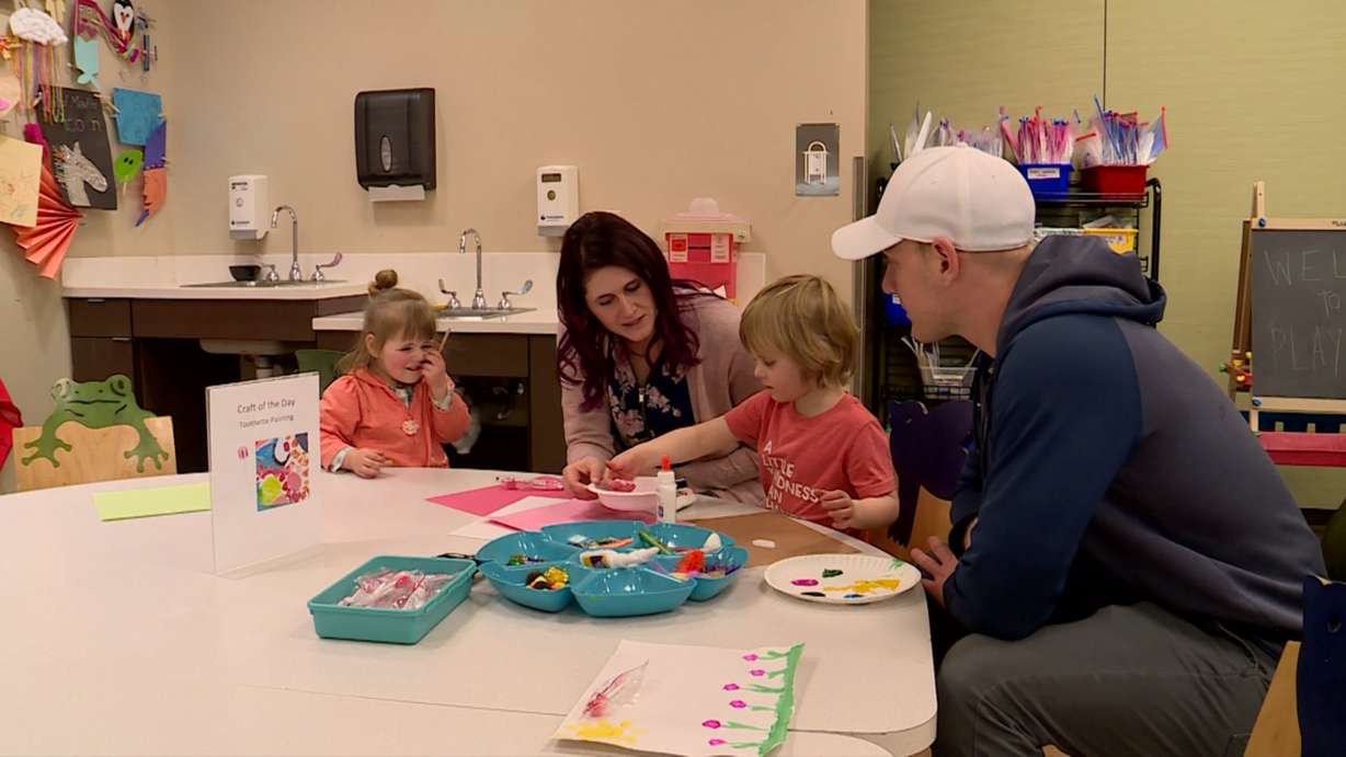 Corbin Cox plays at the craft table with his parents and sister. (Photo: KSL TV)