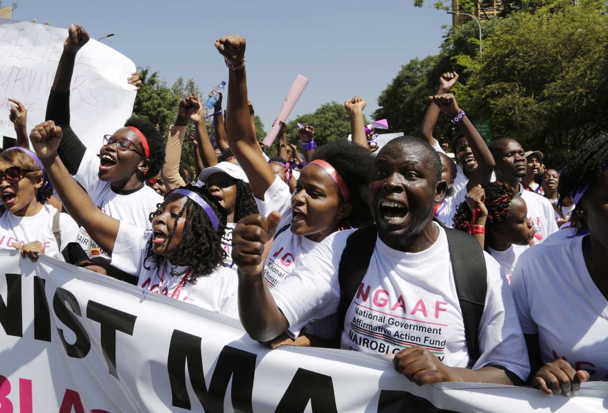Kenyan people shout slogans during a march to mark International Women's Day in Nairobi, Kenya, Friday March 8, 2019. Hundreds of women marched in downtown Nairobi highlighting domestic violence, sexual attacks and discrimination in jobs and wages. (AP Photo/Khalil Senosi)