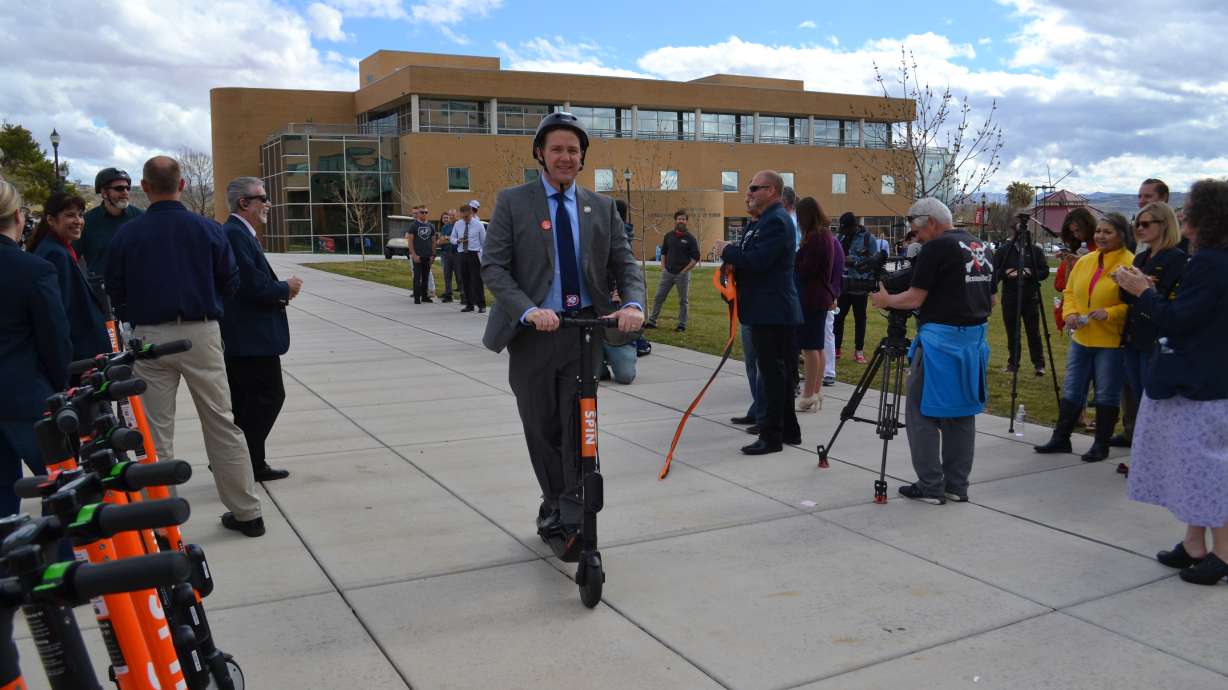 Dixie State University President Richard “Biff” Williams takes the inaugural ride on an e-scooter during a launch event on the Dixie State University campus, St. George, Utah, March 7, 2019 | Photo by Joseph Witham, St. George News