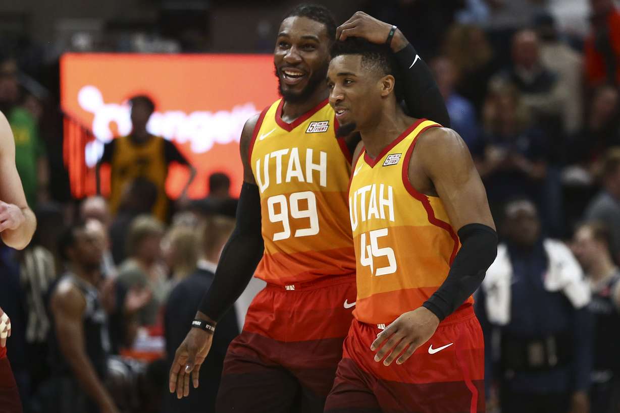 Utah Jazz guard Donovan Mitchell (45) and Utah Jazz forward Jae Crowder (99) embrace during the final moments of the game against the Detroit Pistons at the Vivint Smart Home Arena on Monday, Jan. 14, 2019. (Silas Walker, KSL)