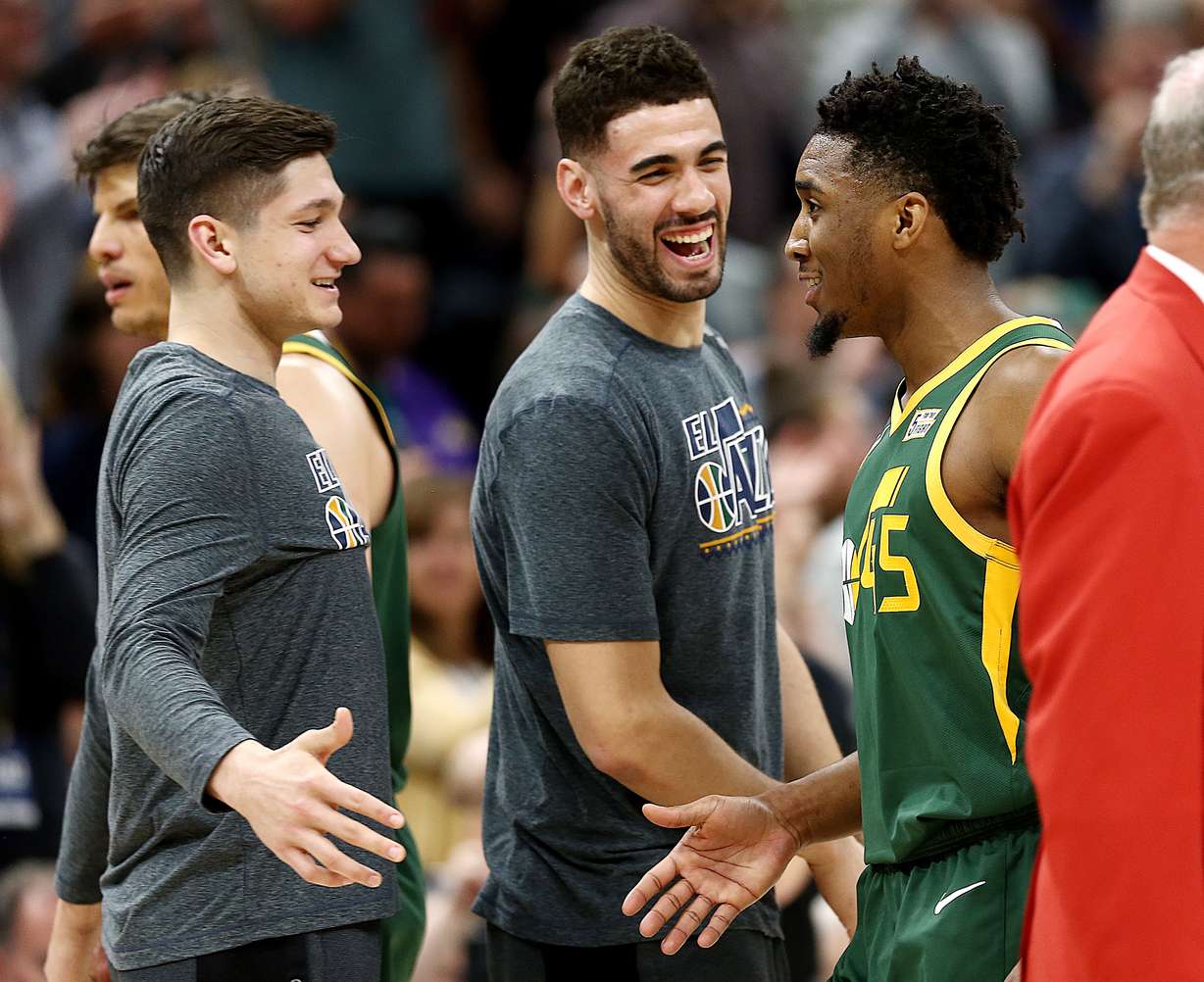 Utah Jazz guard Grayson Allen (24) and Utah Jazz forward Georges Niang (31) congratulate Utah Jazz guard Donovan Mitchell (45) during a timeout as the Utah Jazz and the Milwaukee Bucks play a Vivint Smart Home Arena in Salt Lake City on Saturday, March 2, 2019. Jazz won 115-111. (Scott G. Winterton, KSL)