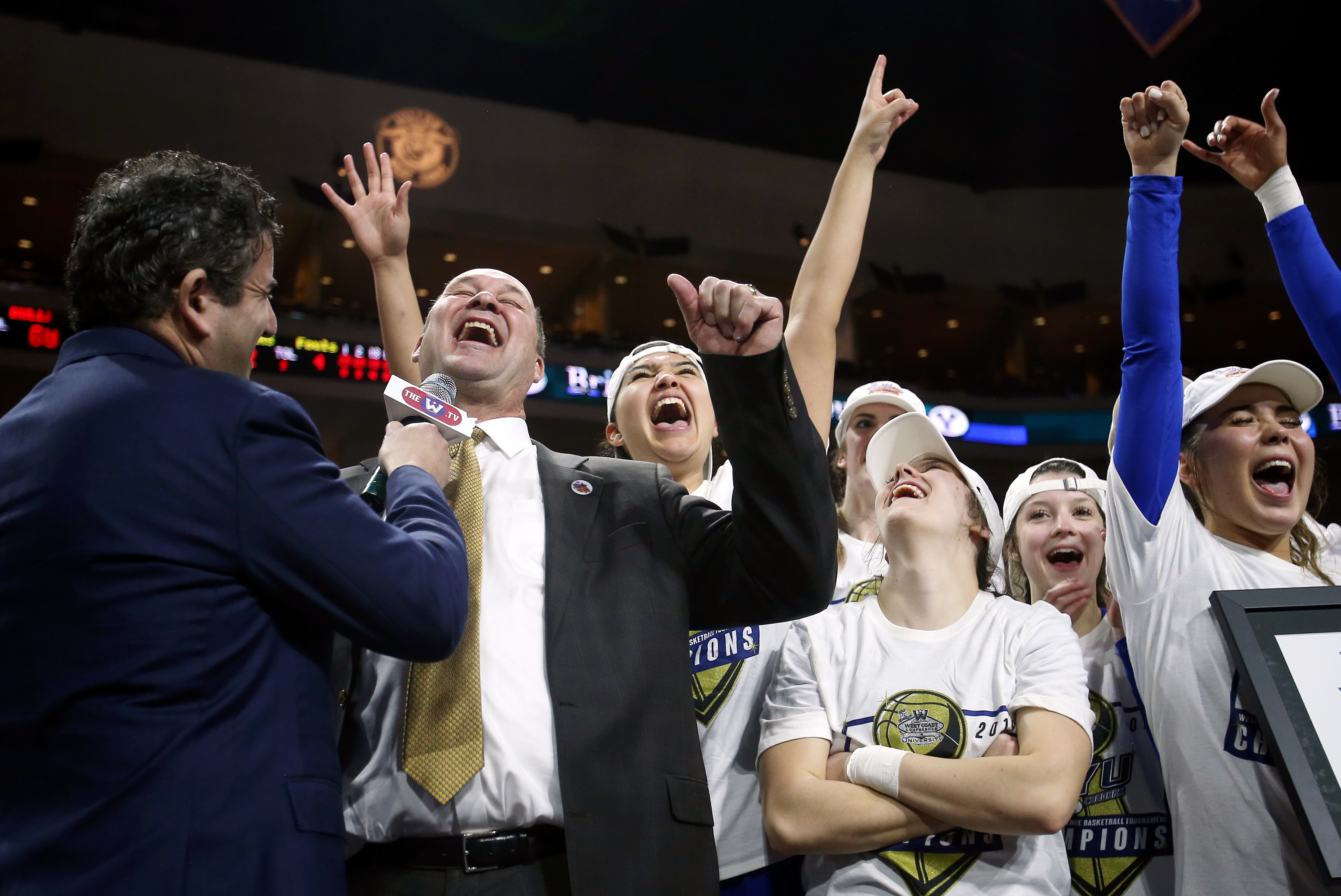 BYU Cougars head coach Jeff Judkins and his team celebrate during their postgame interview after BYU defeated Gonzaga to claim the WCC tournament championship at the Orleans Arena in Las Vegas on Tuesday, March 12, 2019. BYU won 82-68. (Photo: Scott G Winterton, KSL)