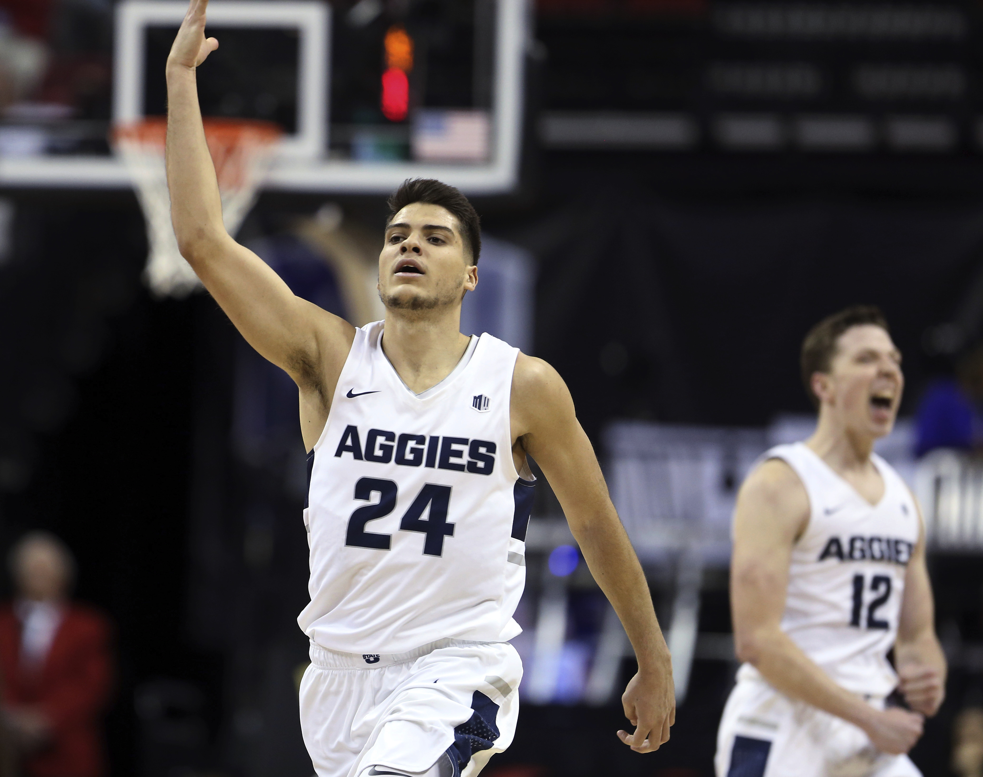 Utah State's Diogo Brito (24) reacts after scoring during the second half of the team's NCAA college basketball game against New Mexico in the Mountain West Conference men's tournament Thursday, March 14, 2019, in Las Vegas. (AP Photo/Isaac Brekken)