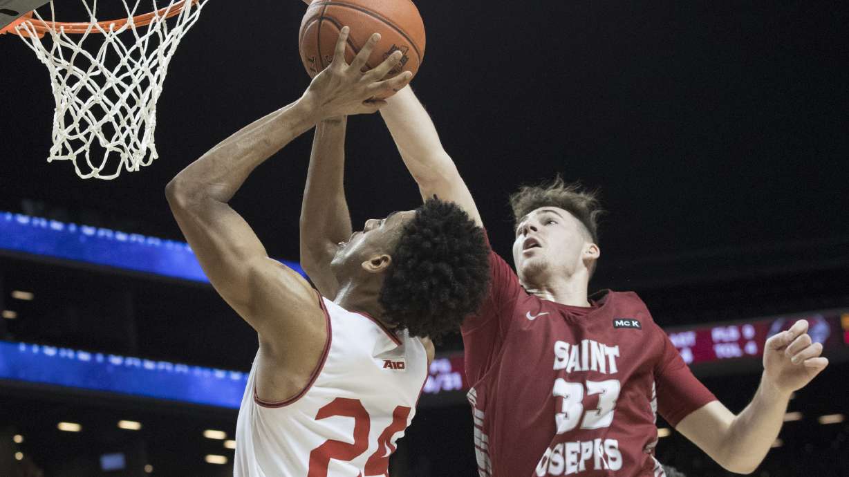 Saint Joseph's forward Taylor Funk (33) stops Davidson guard Carter Collins (24) from scoring during the first half of an NCAA college basketball game in the Atlantic 10 Conference tournament, Friday, March 15, 2019, in New York.
