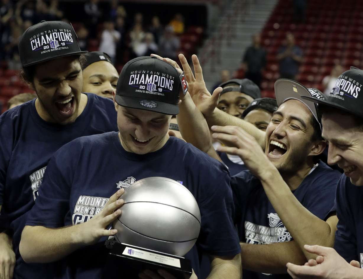 Utah State's Sam Merrill is presented with MVP trophy following an NCAA college basketball game against San Diego State in the Mountain West Conference men's tournament championship Saturday, March 16, 2019, in Las Vegas. (Photo: Isaac Brekken, AP)