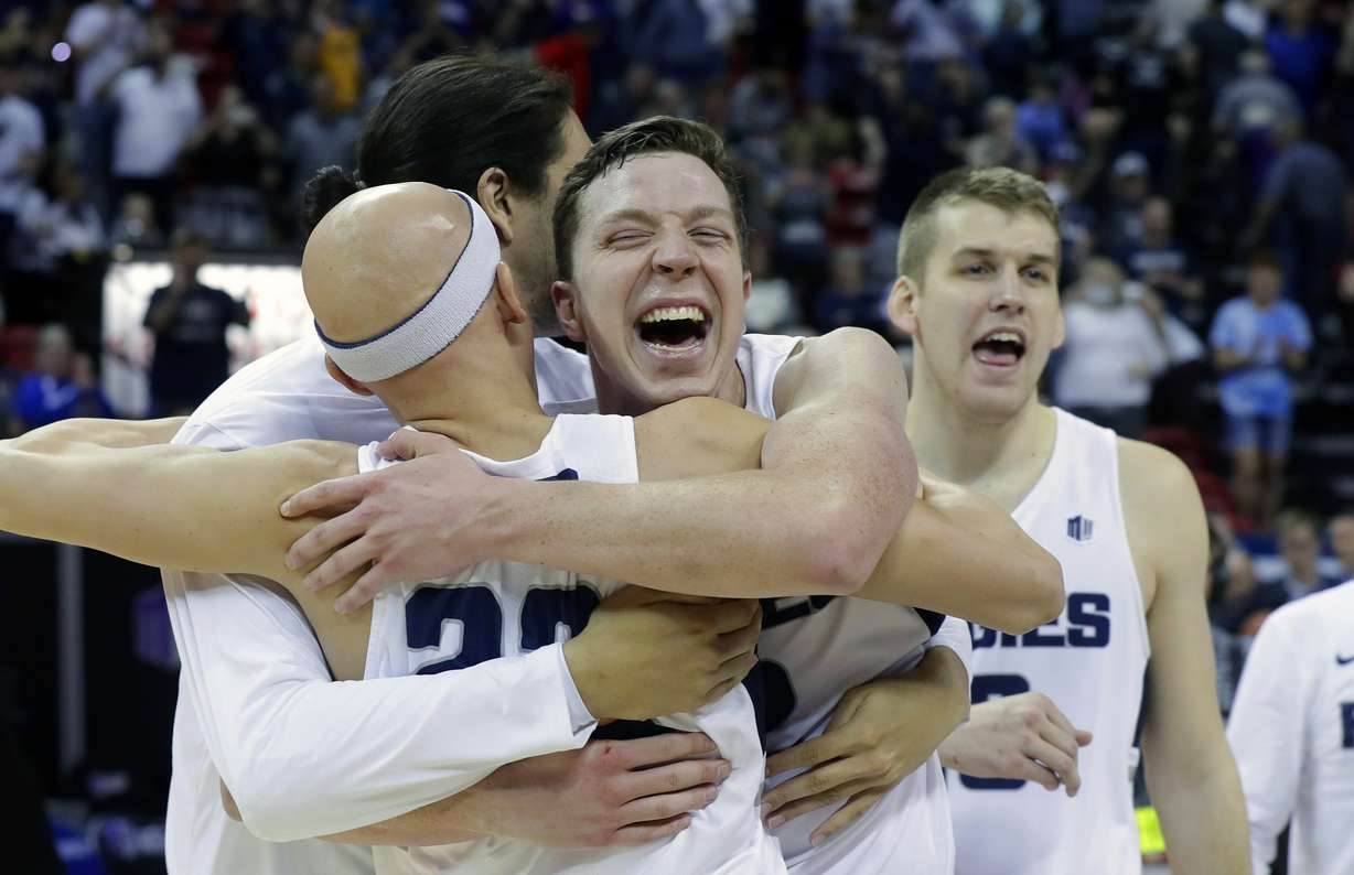 Utah State's Brock Miller, center, celebrates with teammates following an NCAA college basketball game against San Diego State in the Mountain West Conference men's tournament championship Saturday, March 16, 2019, in Las Vegas. (Photo: Isaac Brekken, AP)