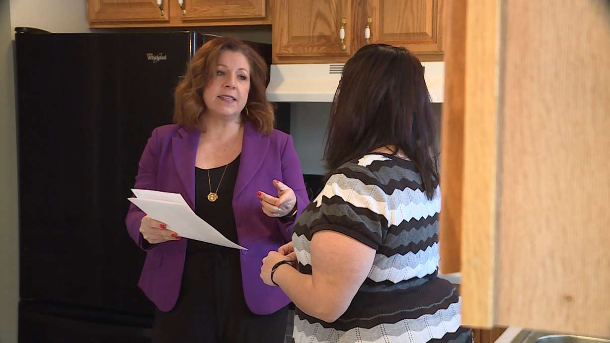 Real estate agent Jennifer Gilchrist reviews a disclosure form with her client, Marie Cornett. (Photo: KSL TV)