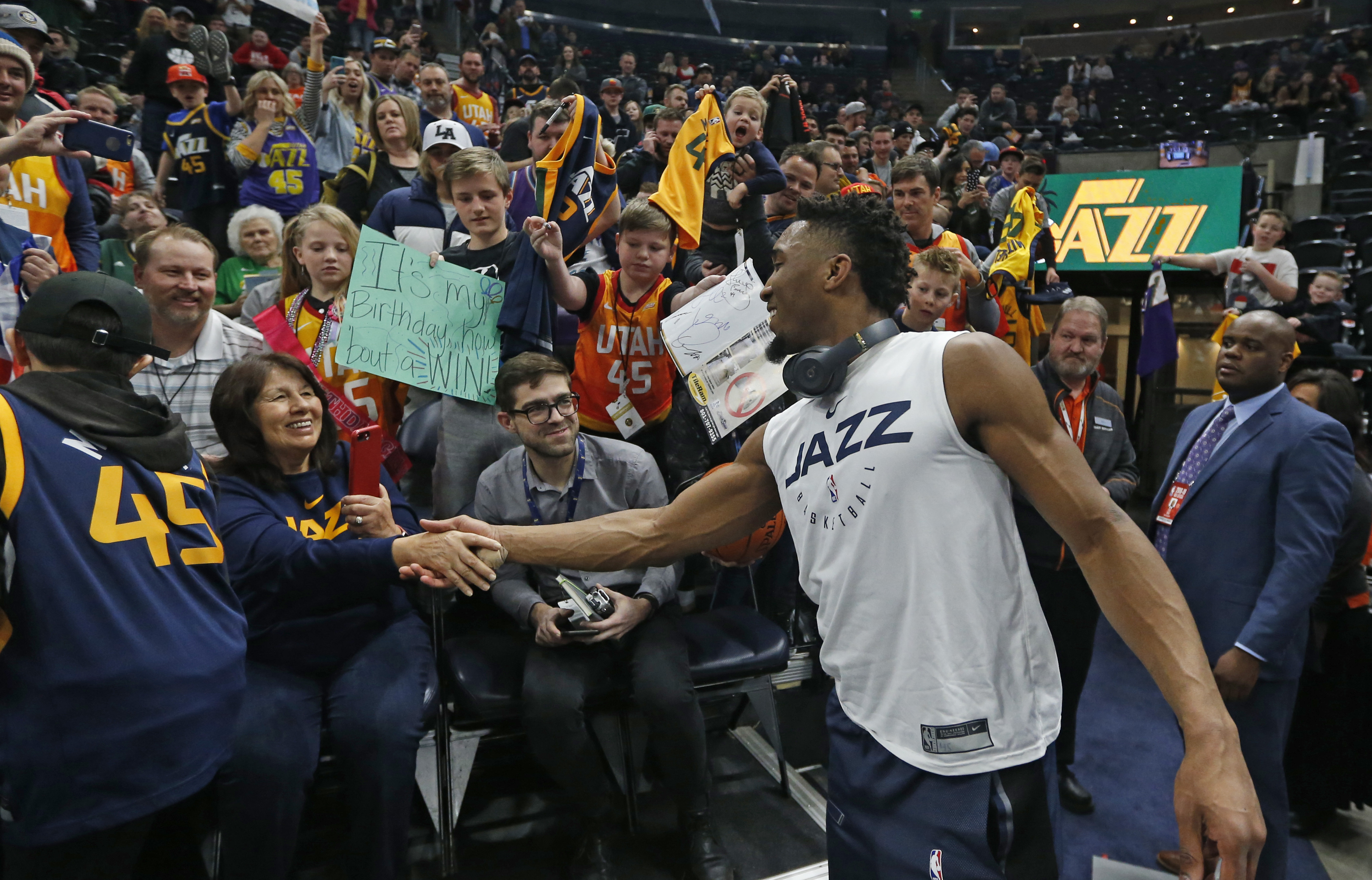 Utah Jazz guard Donovan Mitchell (45) greets fans before the start of their NBA basketball game against the Denver Nuggets Wednesday, Jan. 23, 2019, in Salt Lake City. (AP Photo/Rick Bowmer)