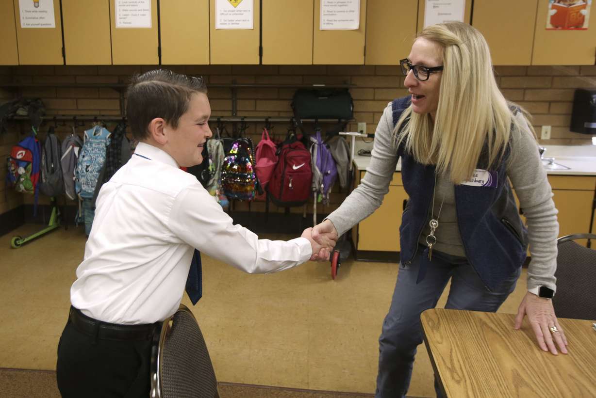 Dylan Manning, a third-grader at Layton Elementary School, shakes hands Jules Brandenburg, who is pretending to be his grandmother, during the Amazing Shake, a social skills competition designed to teach kids how to conduct a proper handshake, have a conversation and think on their feet, at Layton Elementary School in Layton on Wednesday, March 20, 2019. (Photo: Kristin Murphy, KSL)