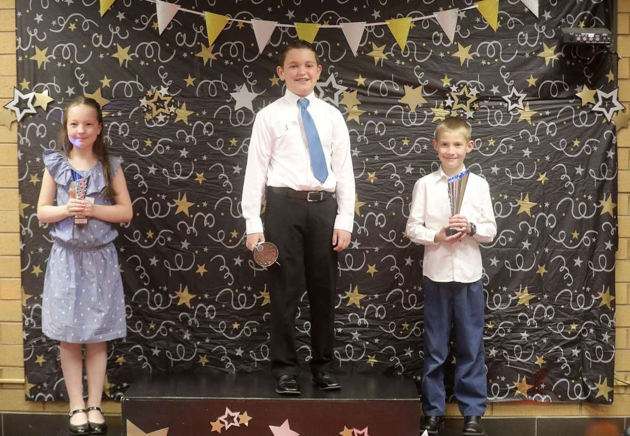 McKell Astill, third-place winner, Dylan Manning, first-place winner, and Eli Yerka, second-place winner, stand on the podium for photos after the Amazing Shake, a social skills competition designed to teach kids how to conduct a proper handshake, have a conversation and think on their feet, at Layton Elementary School in Layton on Wednesday, March 20, 2019. (Photo: Kristin Murphy, KSL)