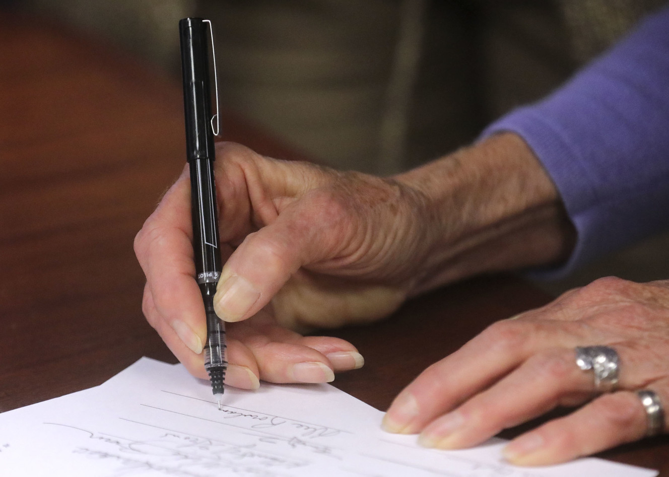 Dee Rowland, who was part of the committee that wrote the original Utah Compact in 2010, signs a new copy of the compact during a press conference at the Salt Lake Chamber in Salt Lake City on Thursday, March 21, 2019. Community leaders reaffirmed their support of compact, a set of principles to guide the immigration discussion. (Photo: Kristin Murphy, KSL)