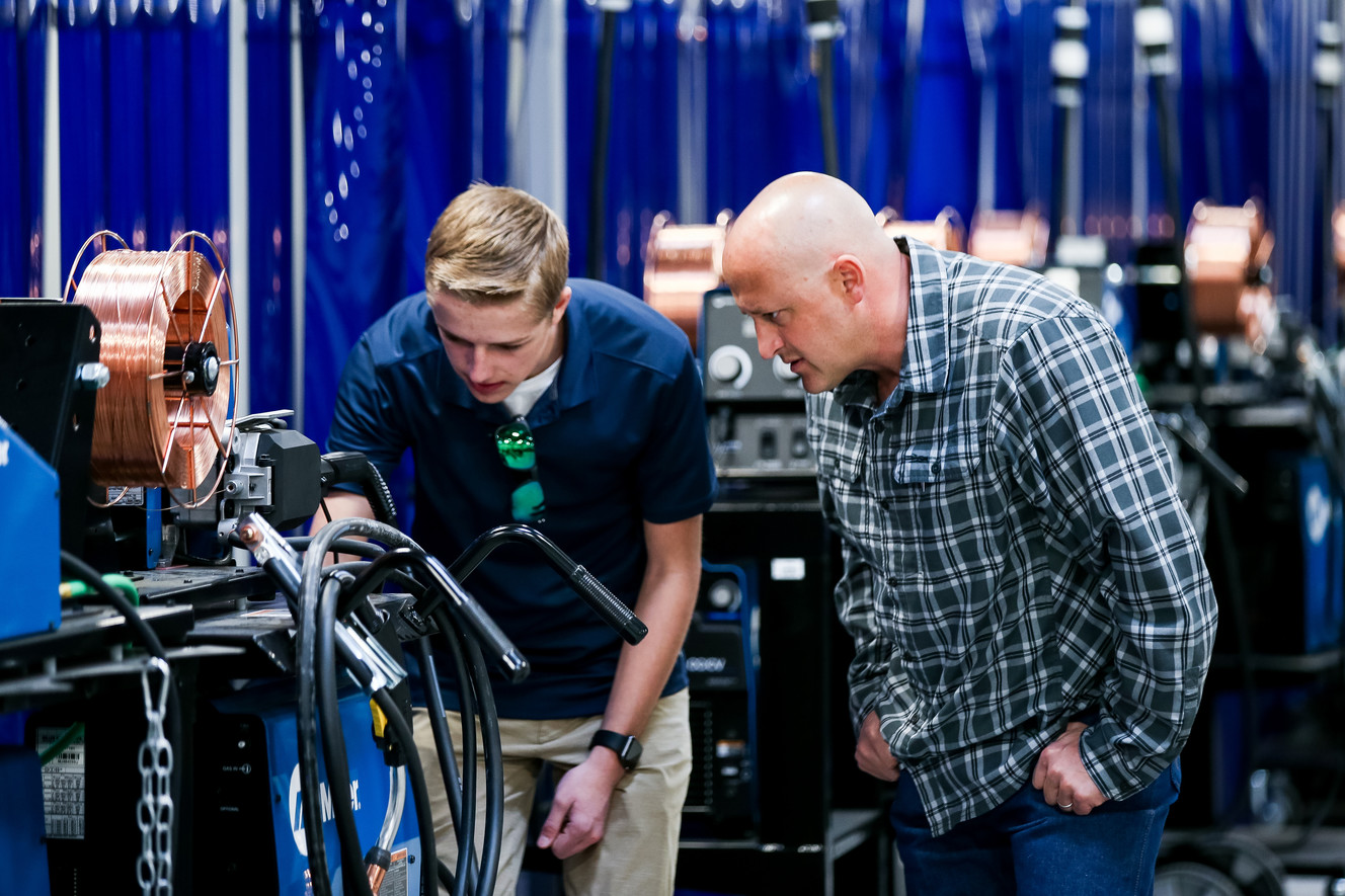 Alec Goodrich, 16, who is enrolled in classes at Uintah Basin Technical College, and his father, Jesse Goodrich, both of Vernal, check out welding stations during the opening of the school's new Welding Technology Building in Roosevelt on Thursday, March 21, 2019. (Photo: Spenser Heaps, KSL)