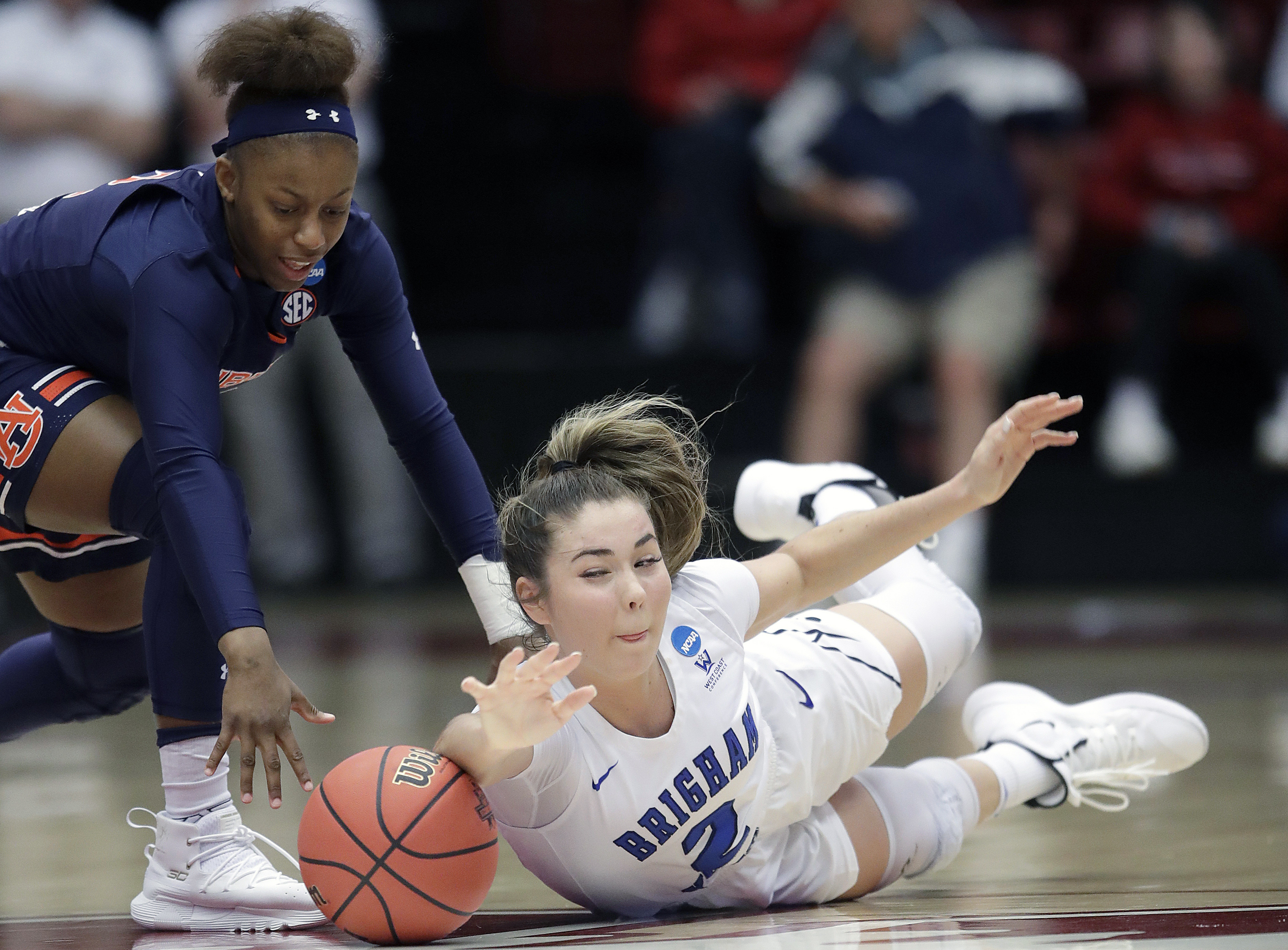 BYU guard Shaylee Gonzales, right, dives for a loose ball under Auburn guard Brooke Moore during the first half of a first-round game in the NCAA women's college basketball tournament in Stanford, Calif., Saturday, March 23, 2019. (Photo: Jeff Chiu, AP)