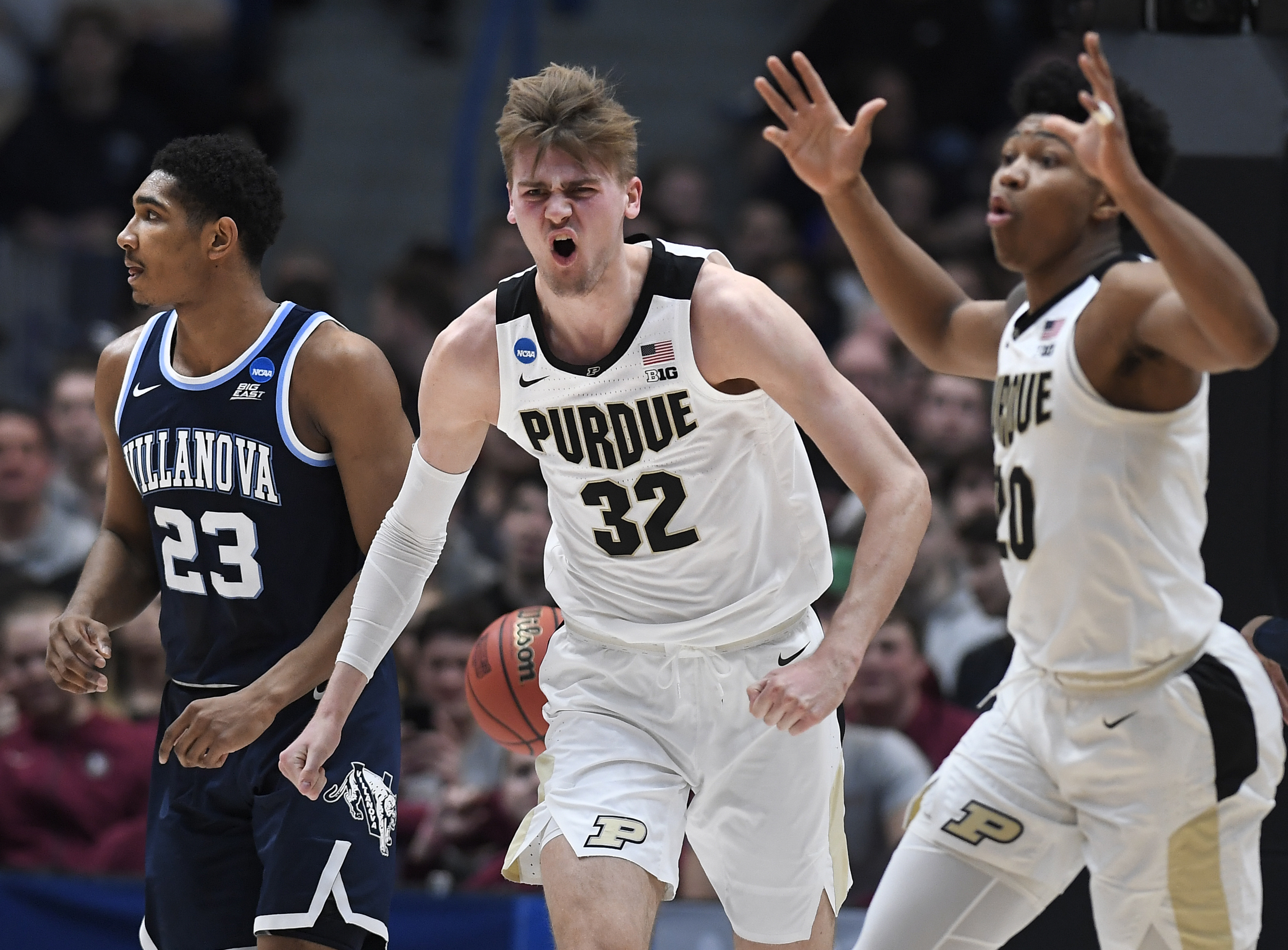 Purdue's Matt Haarms (32) and Purdue's Nojel Eastern (20) react to a basket bay Haarms during the first half of a second round men's college basketball game in the NCAA tournament, Saturday, March 23, 2019, in Hartford, Conn. (AP Photo, File)